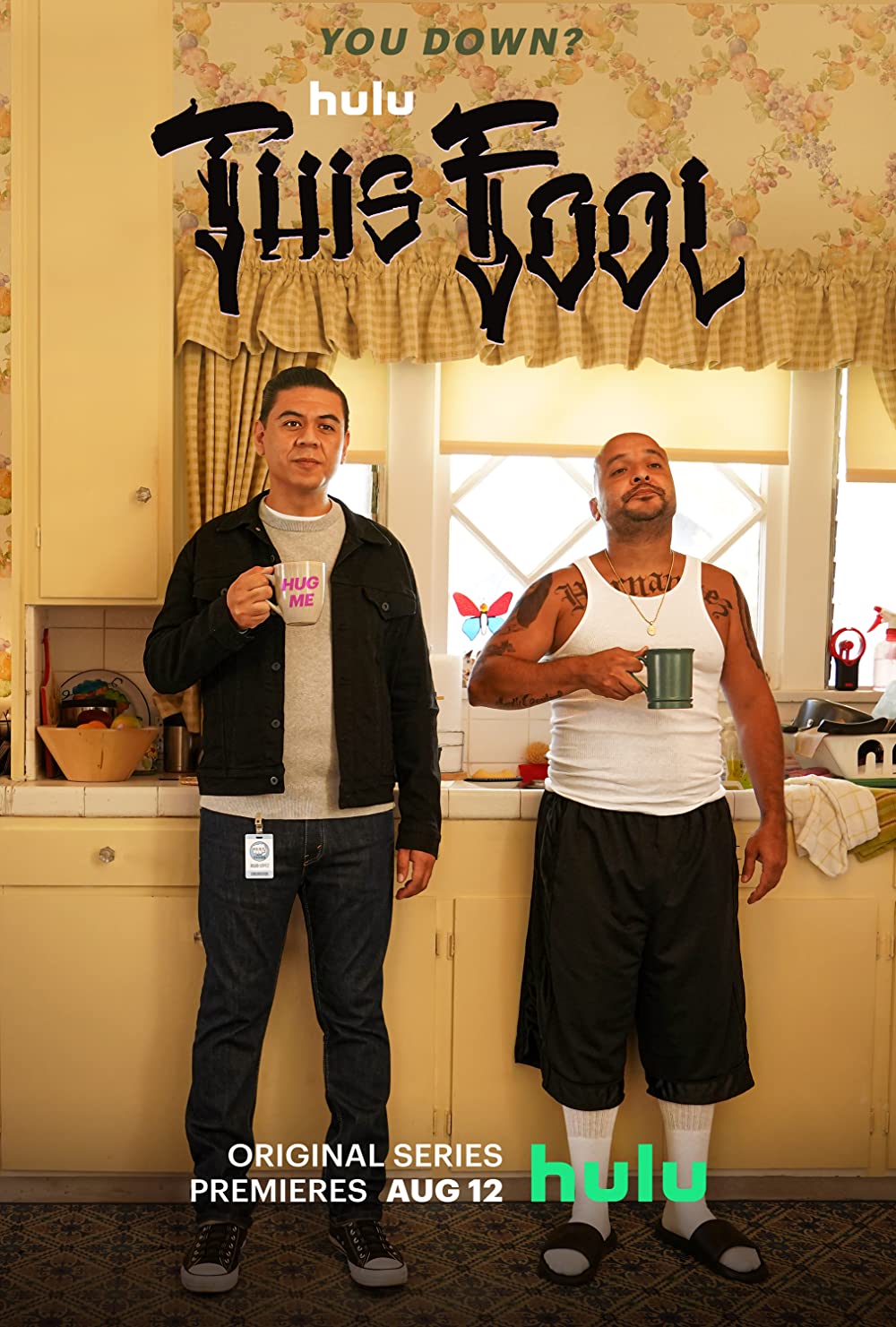 the image for this fool shows two men standing in a kitchen with coffee cups. they are mirroring each others body language.