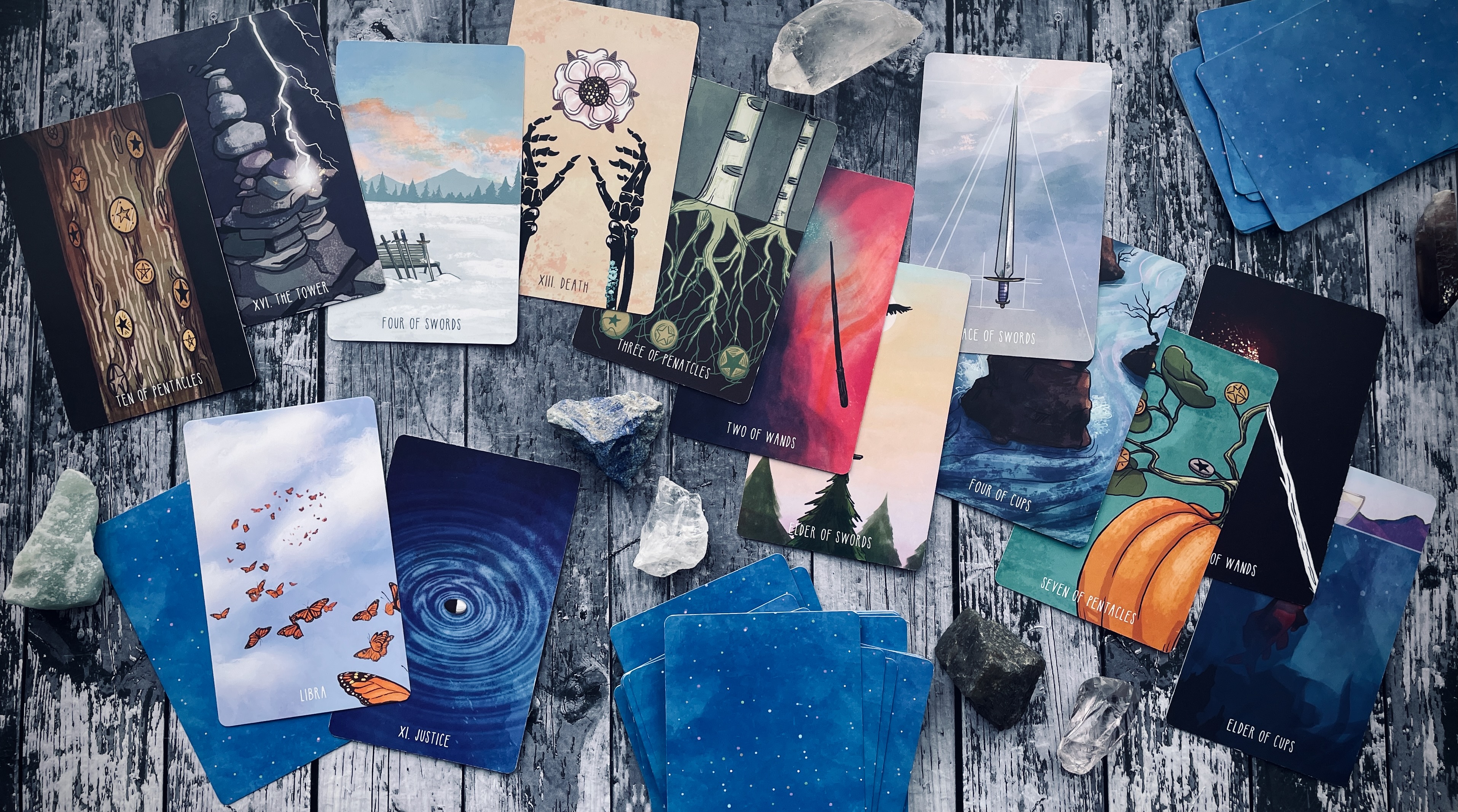 spacious tarot & spacious tarot expansion pack, spread out on a grey wood table