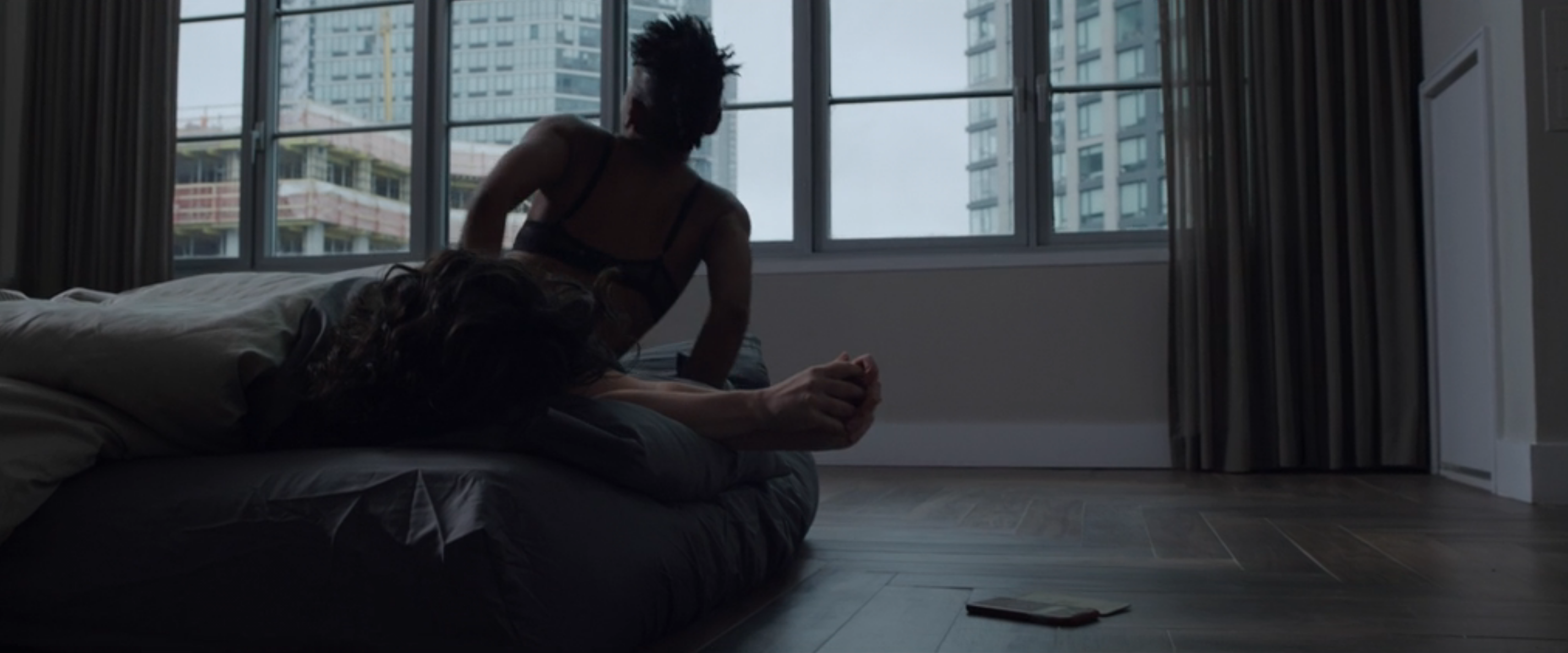 Carmen from The Good Fight in bed with someone with dark curly hair