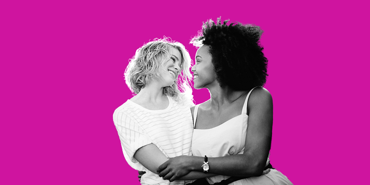 a stock photo of two women looking very much in love in black and white set against the signature hot pink of the Stacy's Mom music video by Fountains of Waine