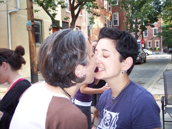 Tracy and Mia in a recent photo are at a block party in Philadelphia where they both appear to be trying to bite the same cherry at the same time, without use of their hands