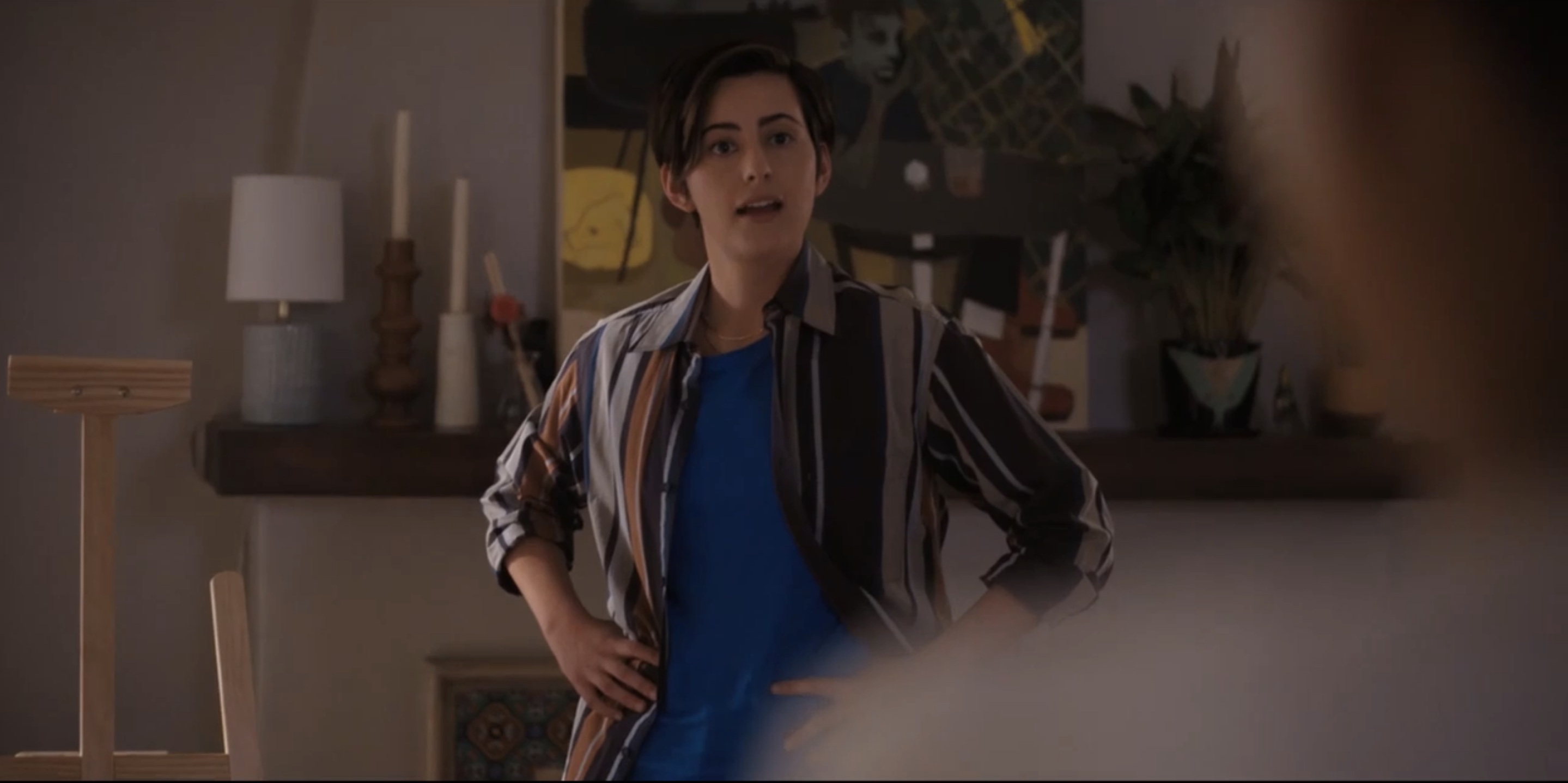 Finley with her hands on her hips standing in front of the easel she just built