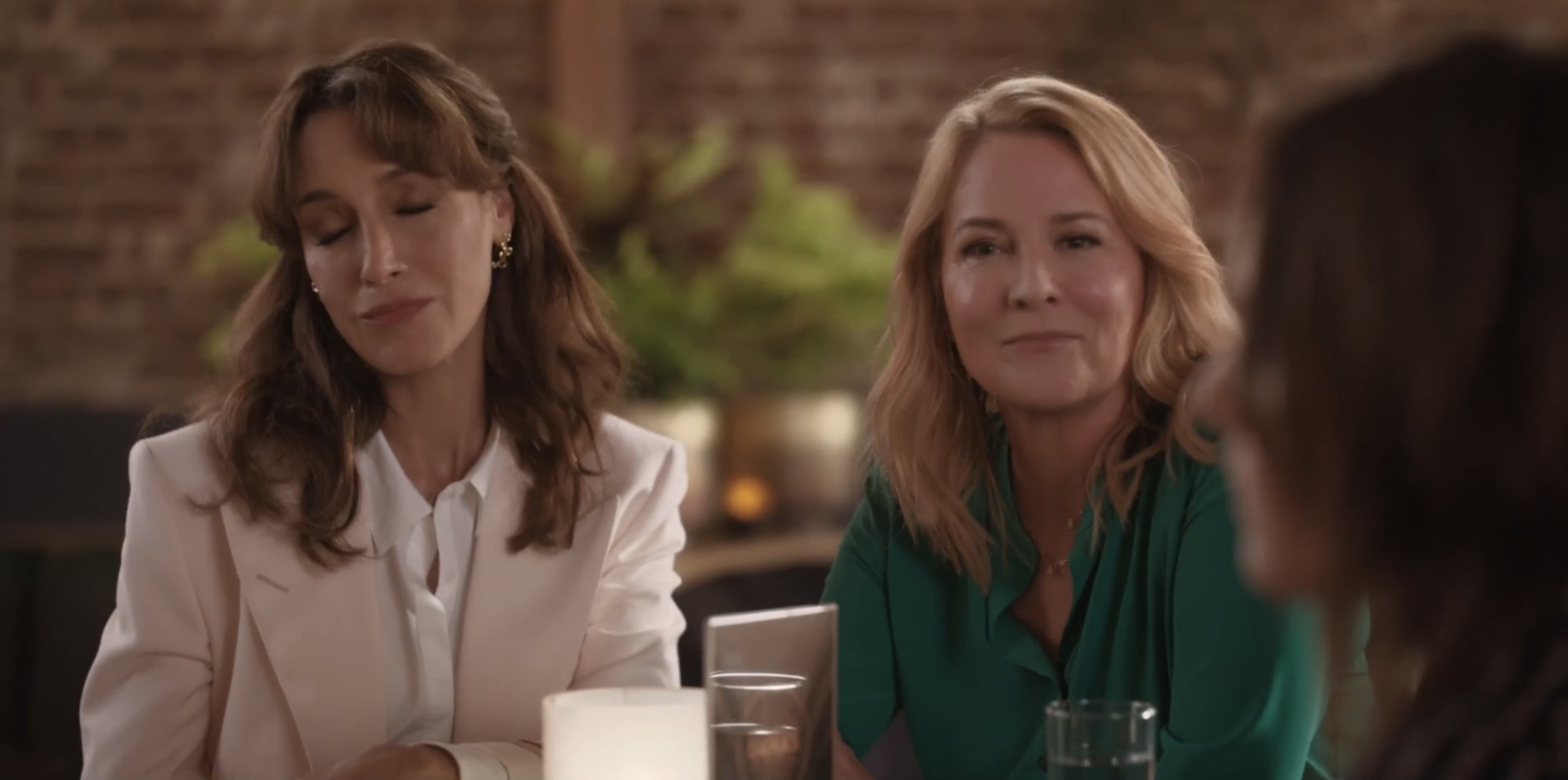 Bette and Tina looking a little smug but cute at the table