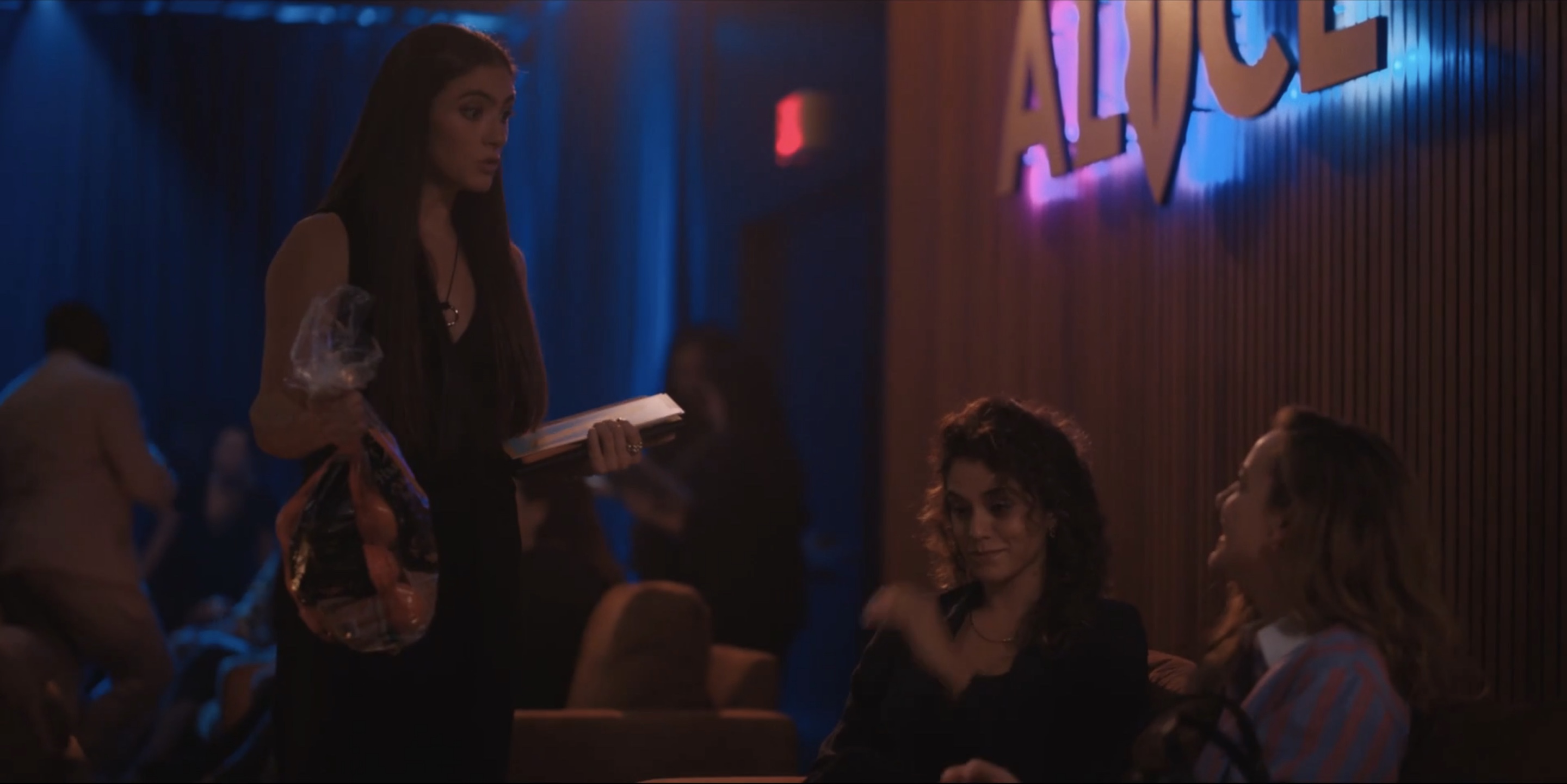Dani holding the bag of oranges that Nat just handed to her