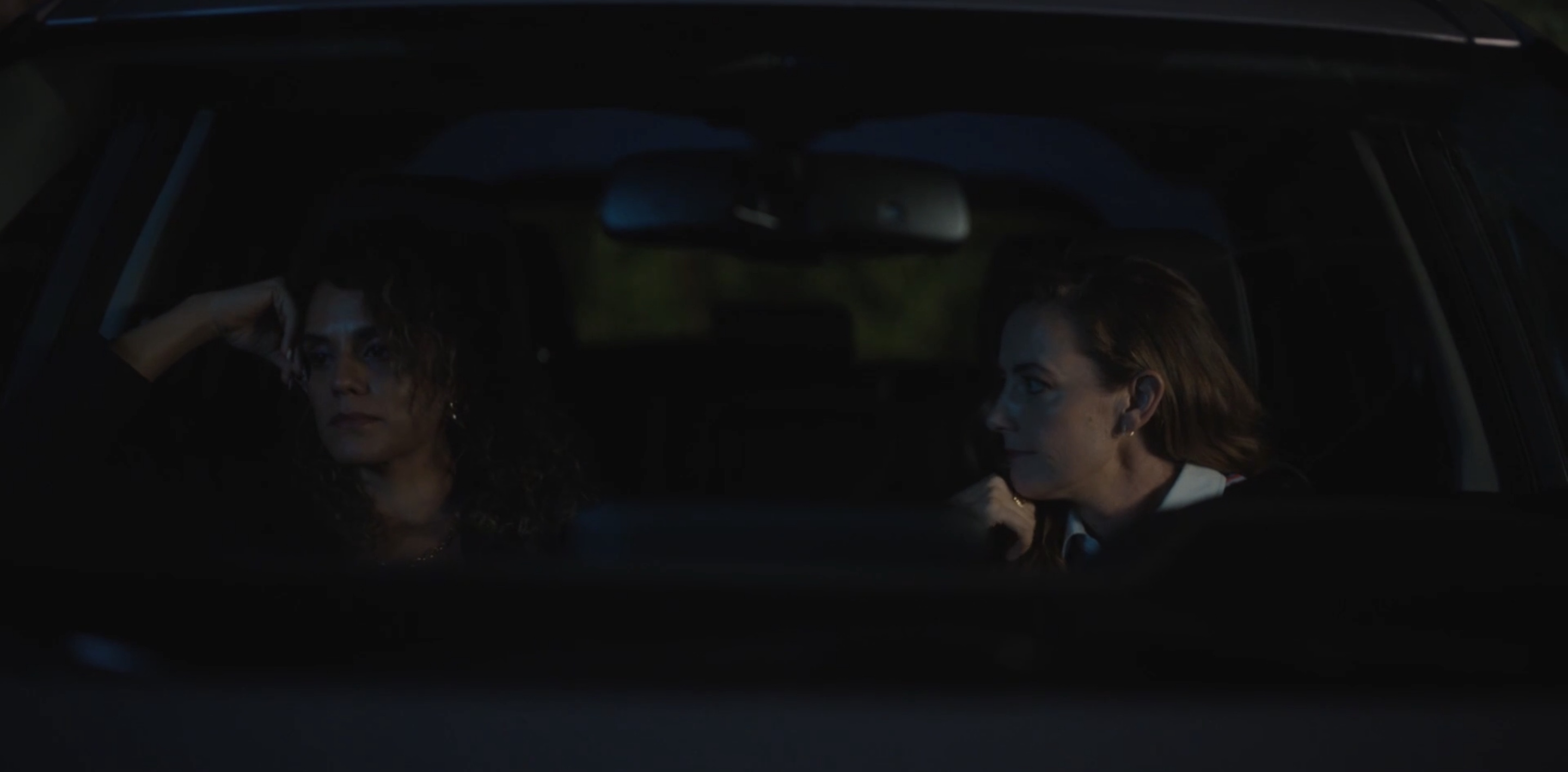 Gigi and Nat are sitting in her car