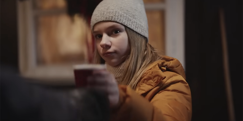 A teenage girl noticing her competitor isn't selling much cocoa
