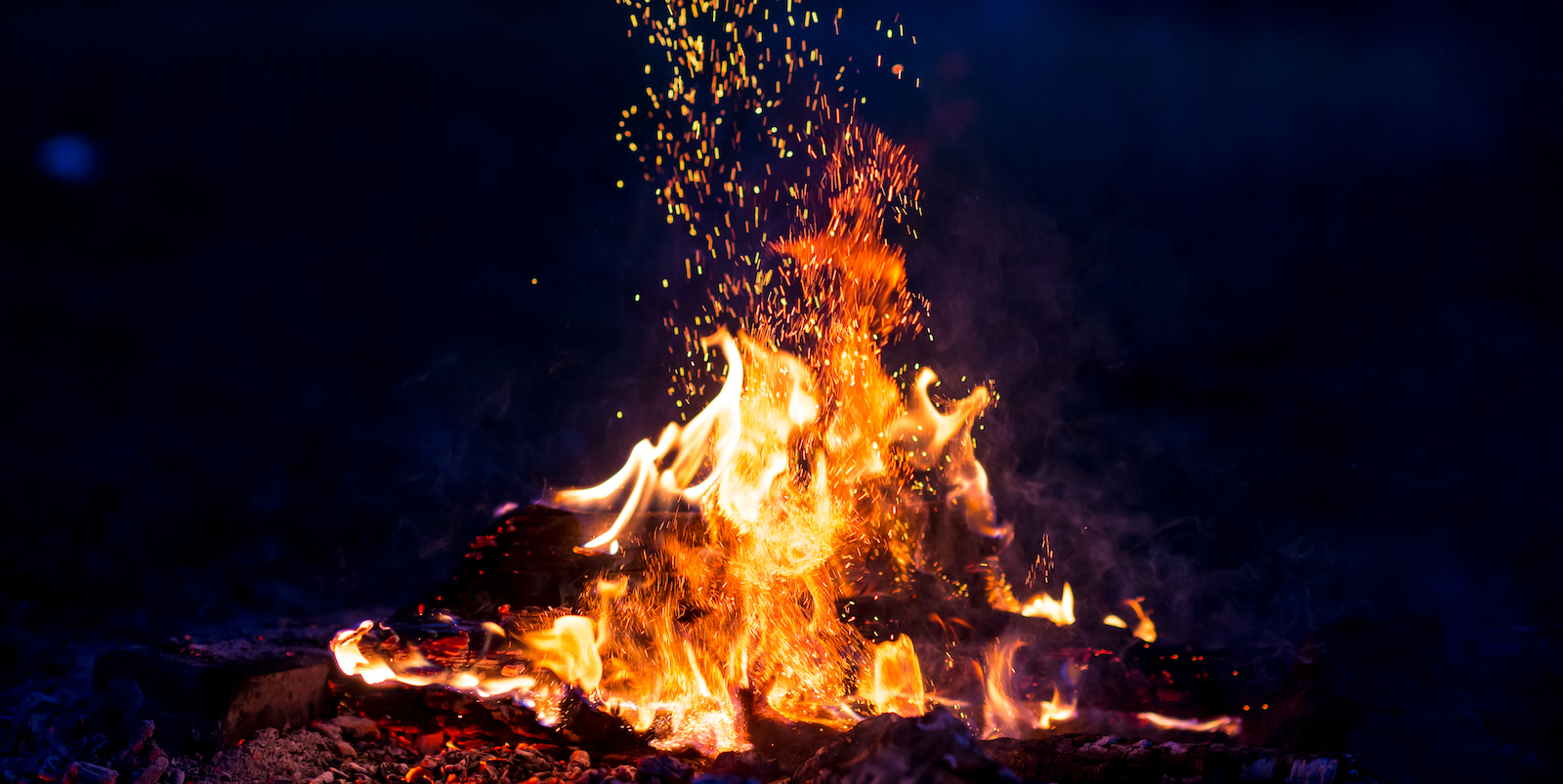 a bright fire burning strongly in the night