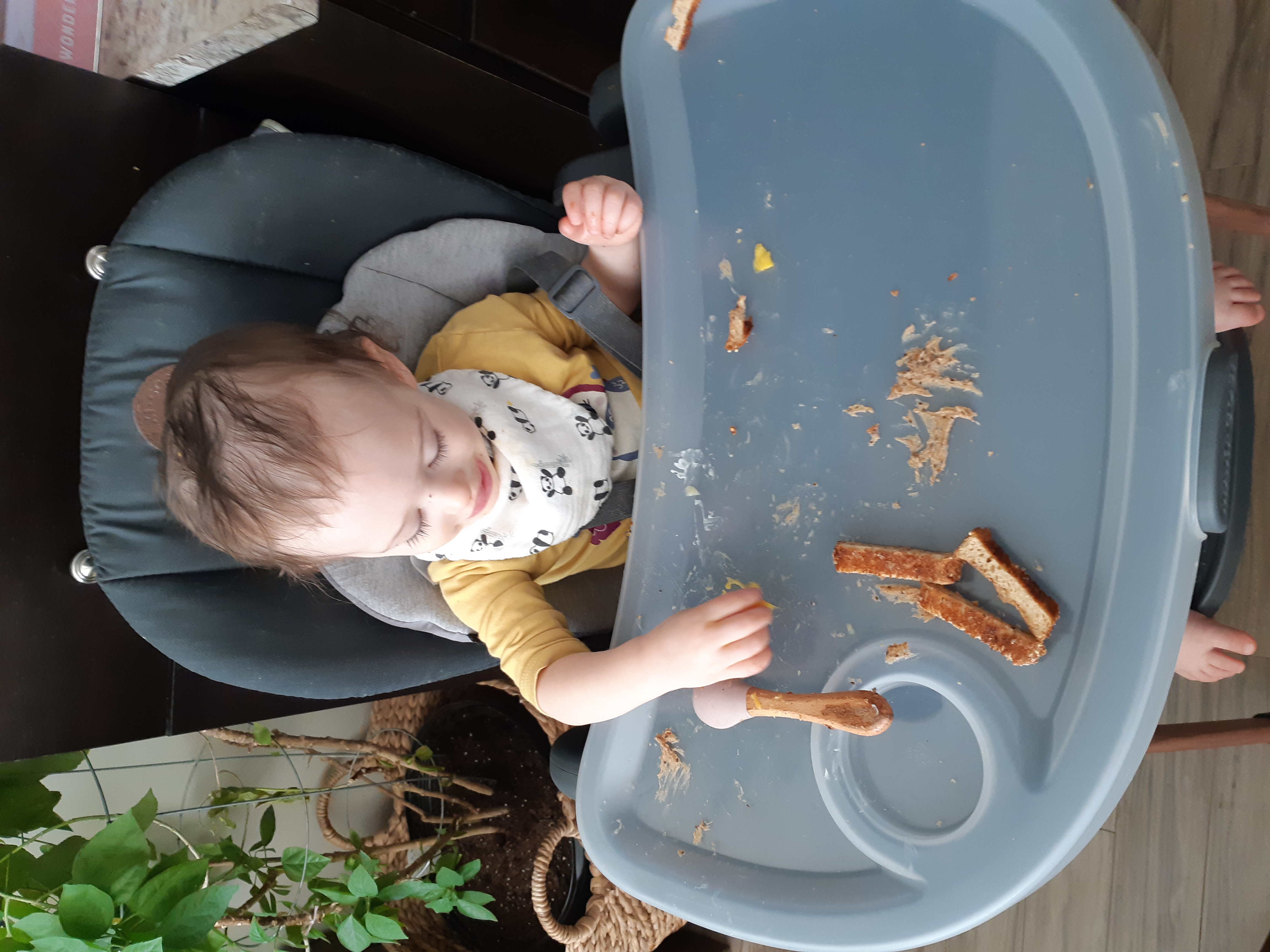 baby jimena eats at a high chair