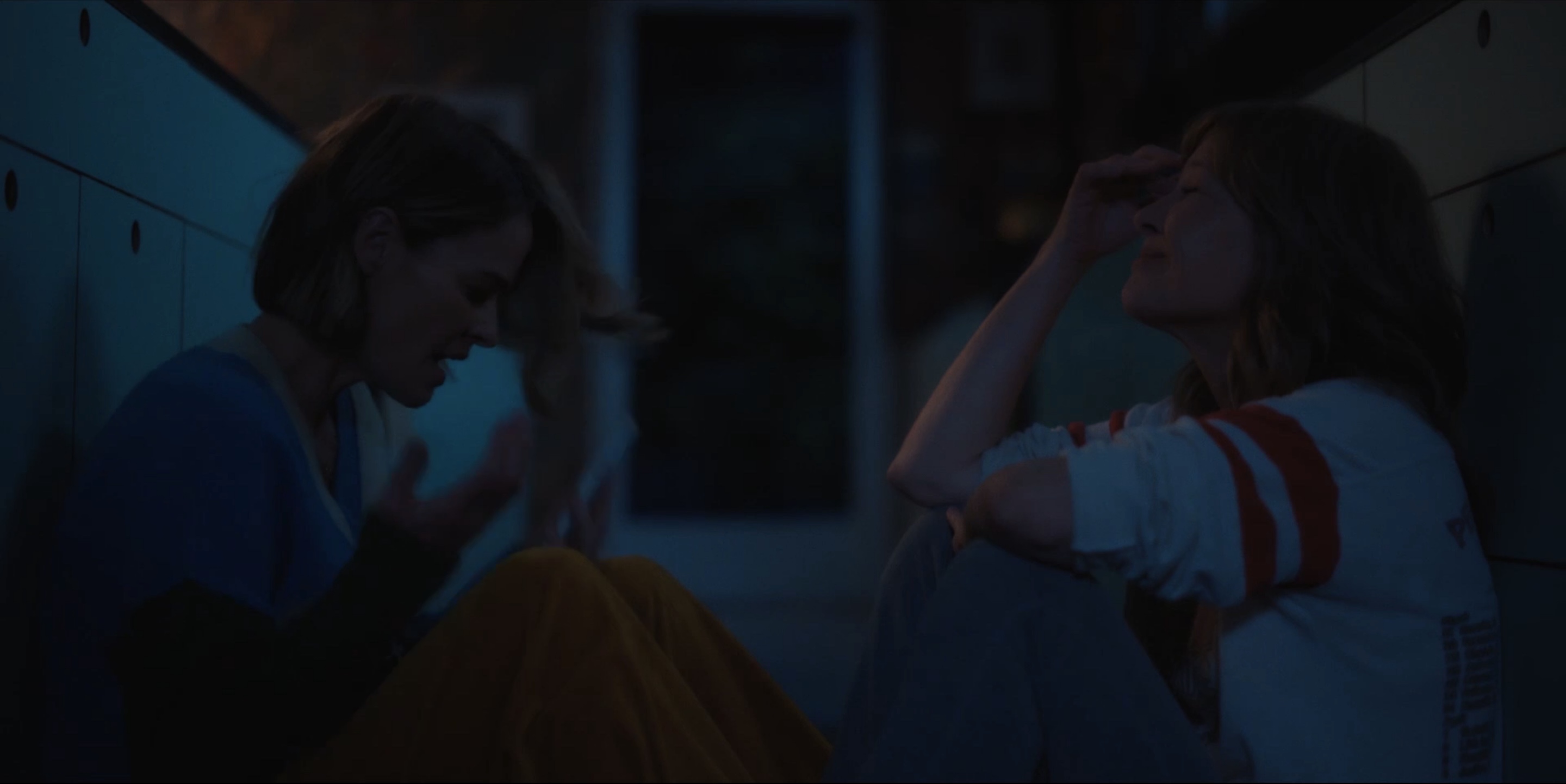 Alice and Taylor sitting on the floor in her kitchen