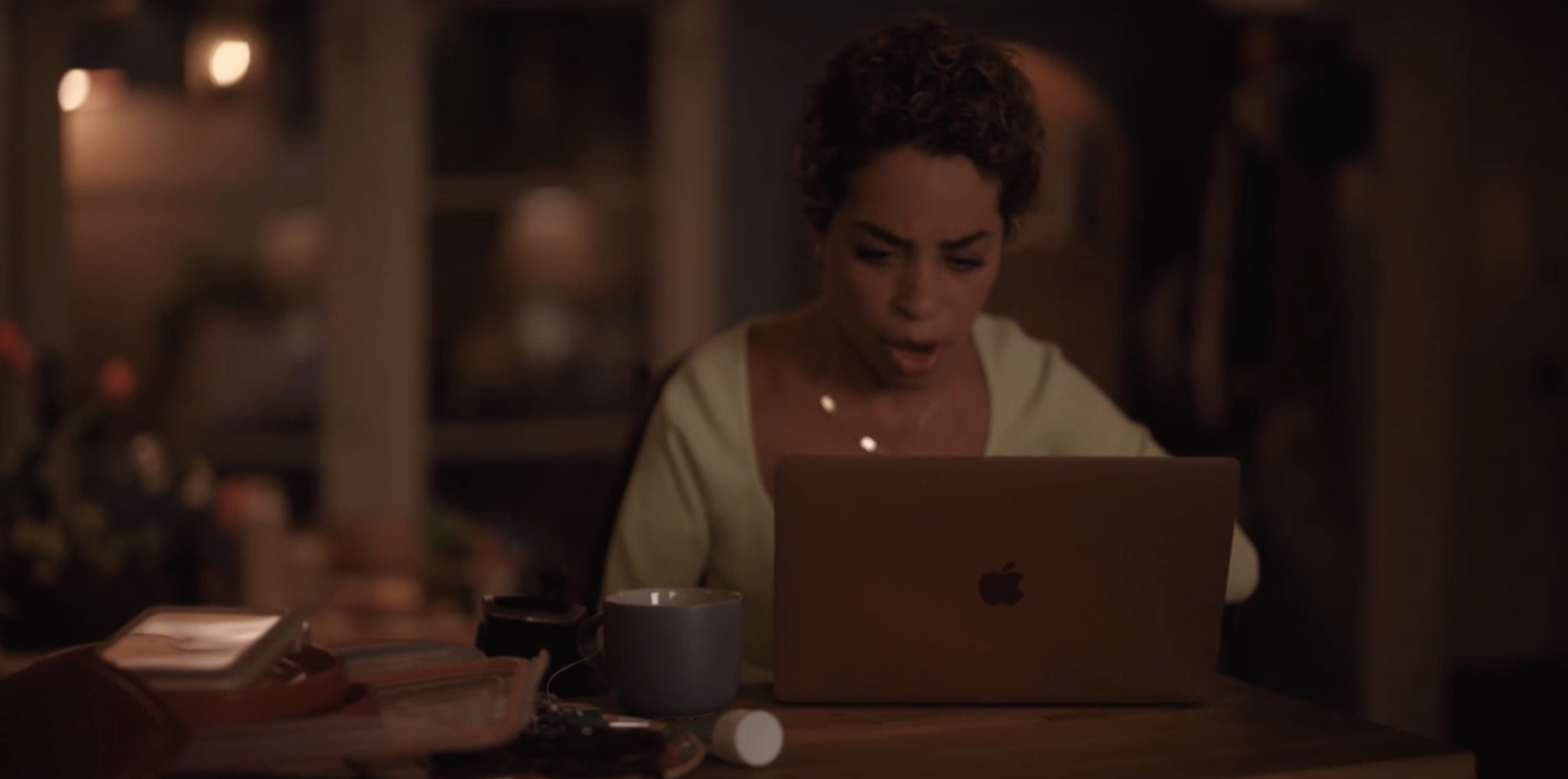 Maribel looking surprised by what she sees on her laptop