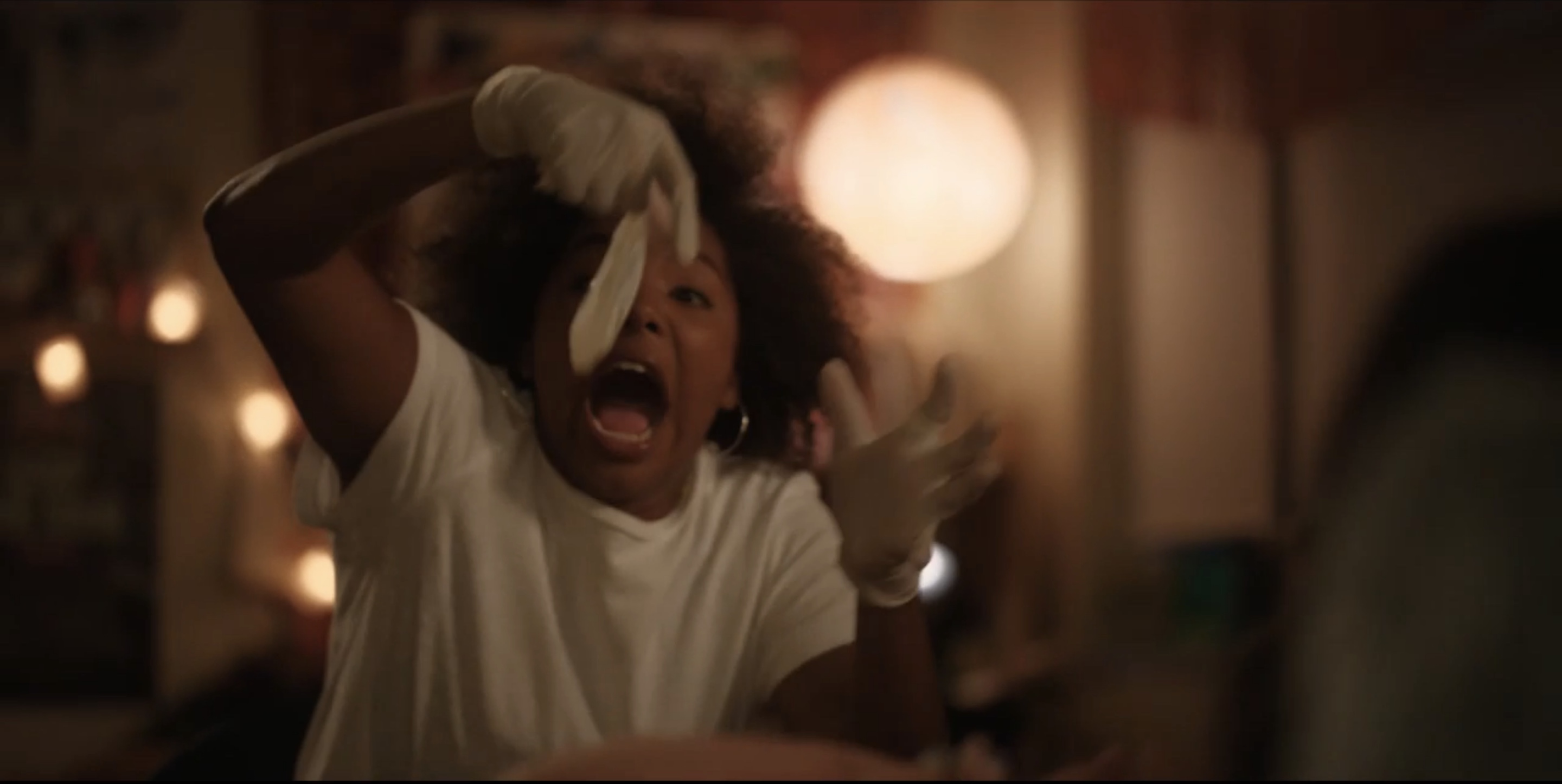 Angie holding the condom and screaming