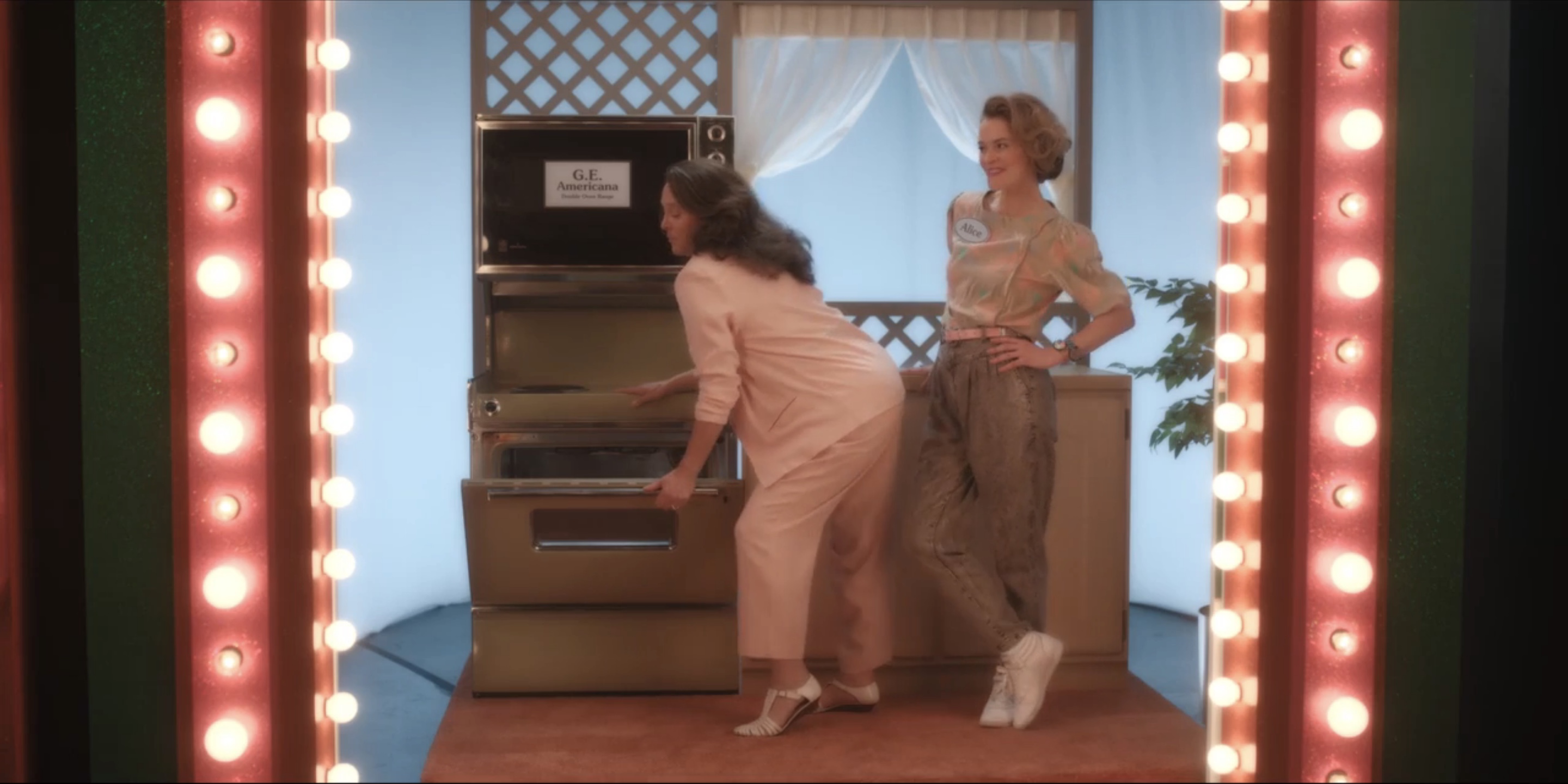 Dana opening the stove, Alice standing next to her