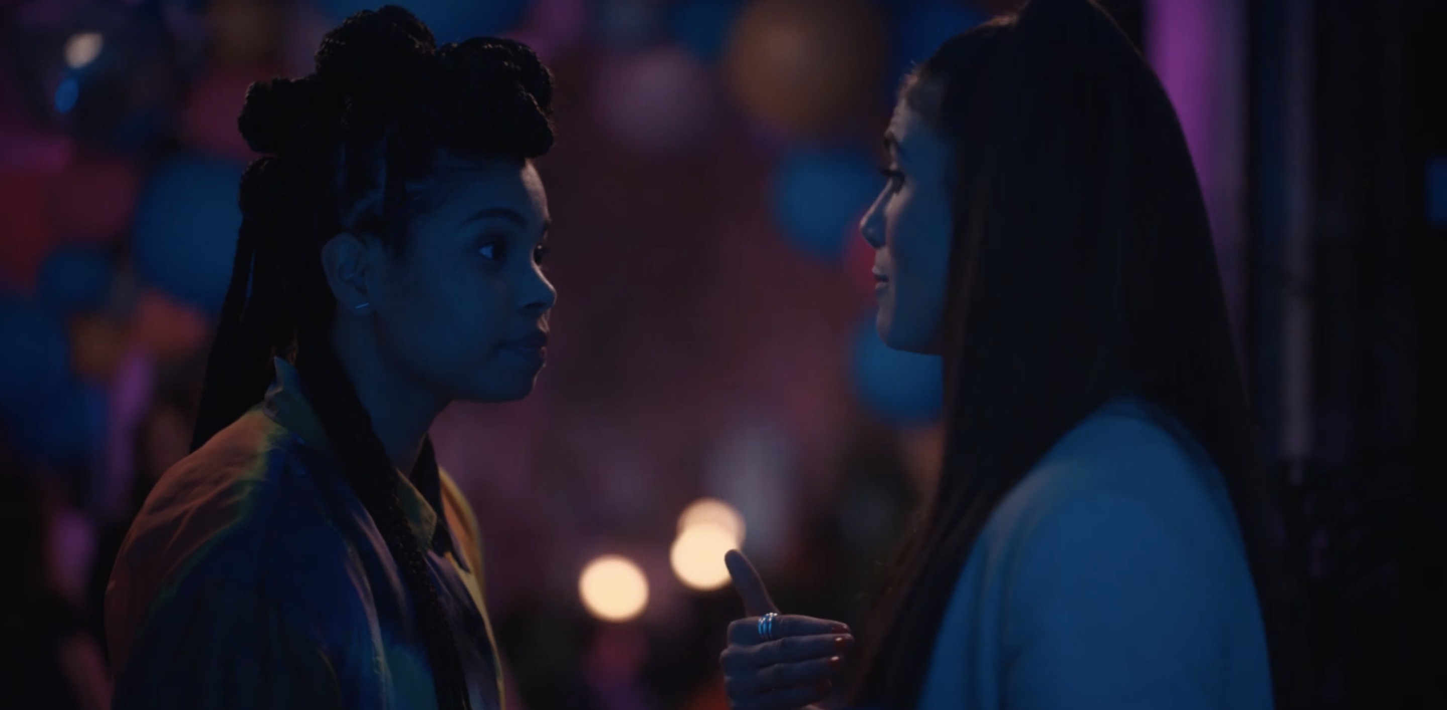 Dani and Dre talking to each other at the Fletcher party