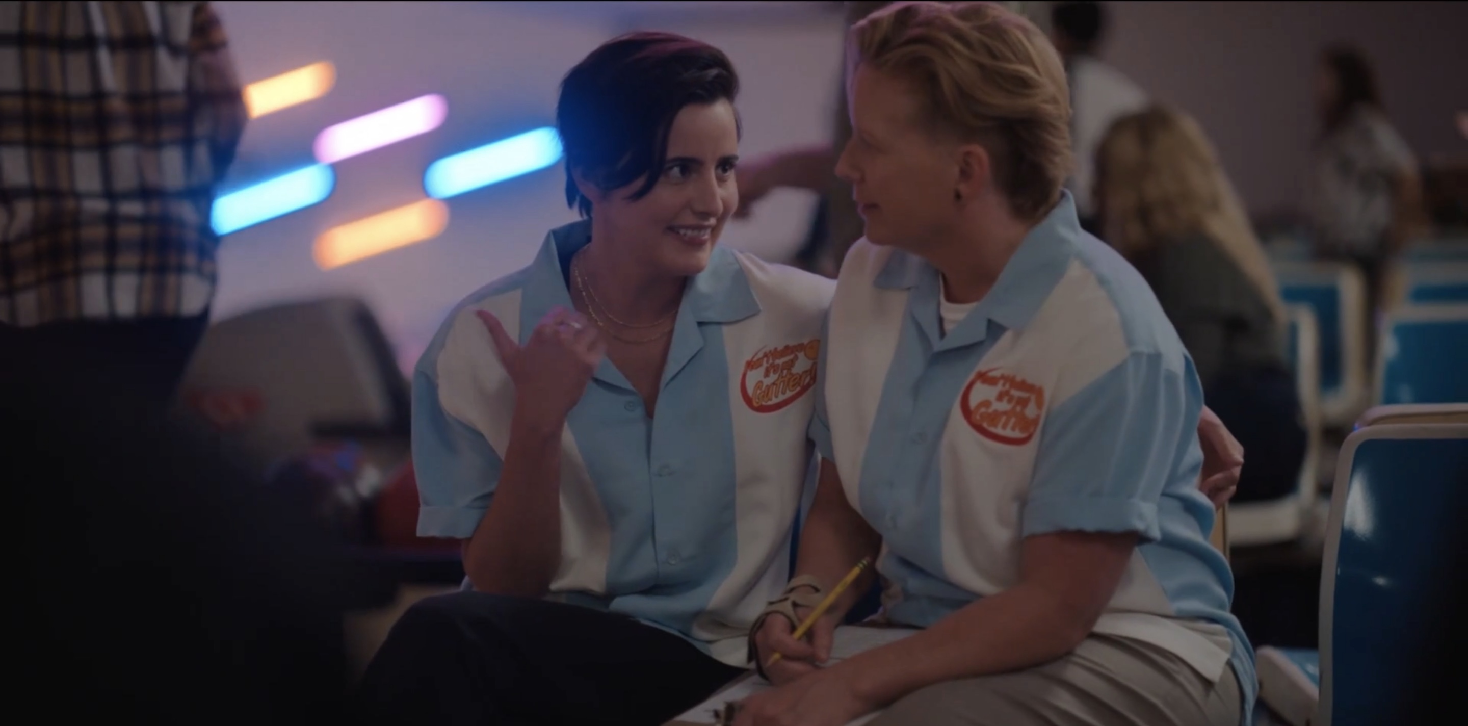 Finley with her arm around Misty pointing behind her with her thumb