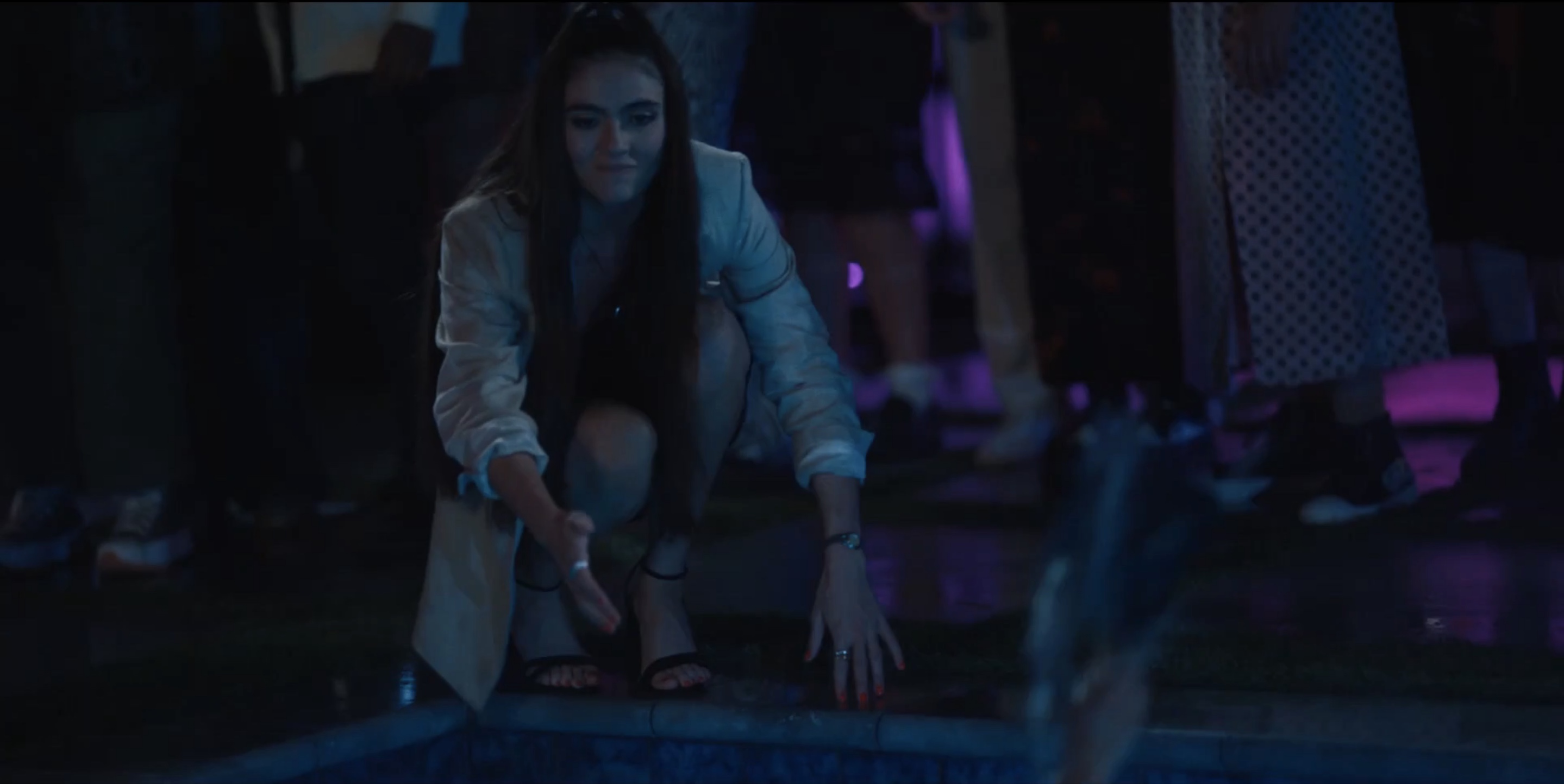 Dani reaching over the pool's edge