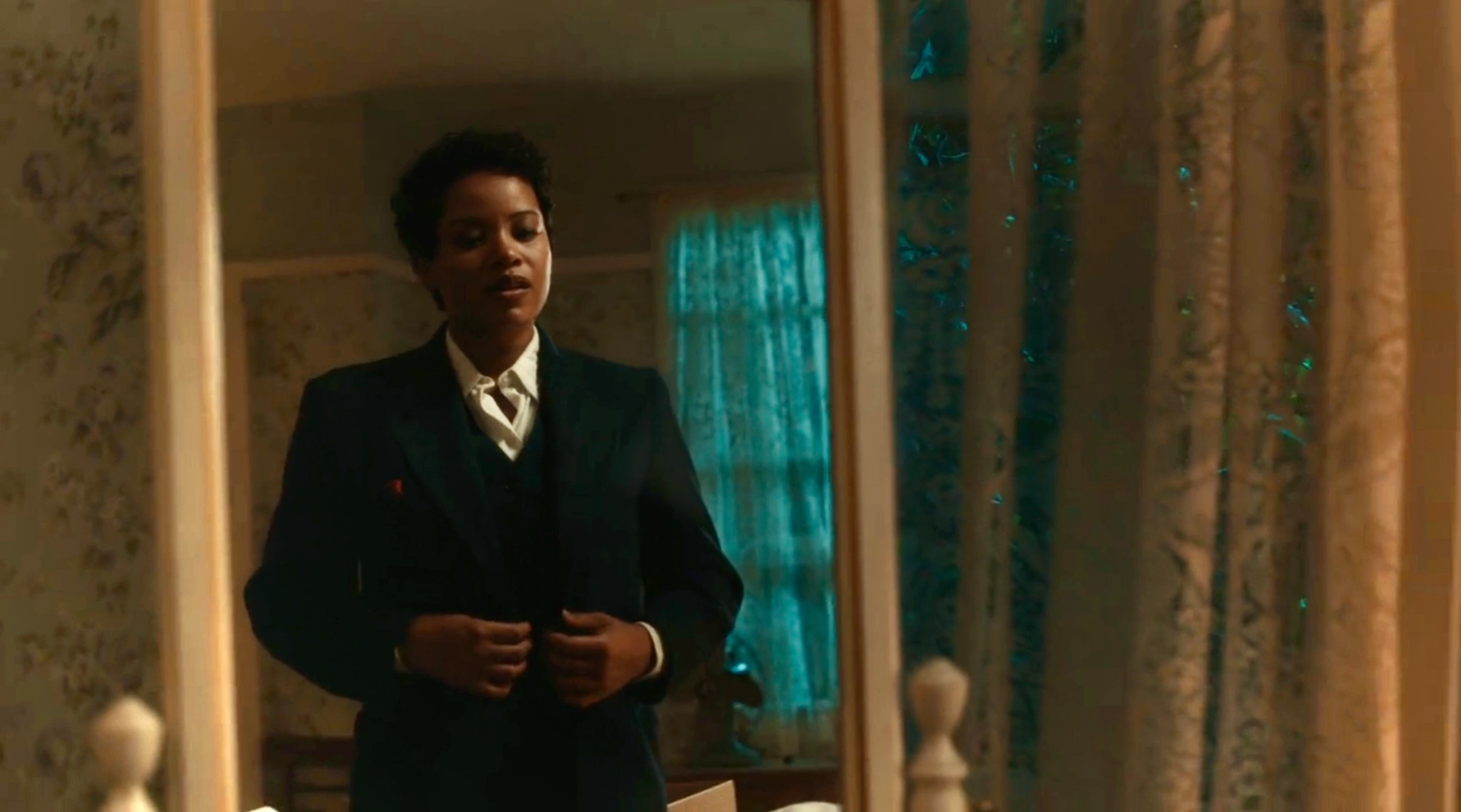Max looks in the mirror while wearing the suit Uncle Bert made for her