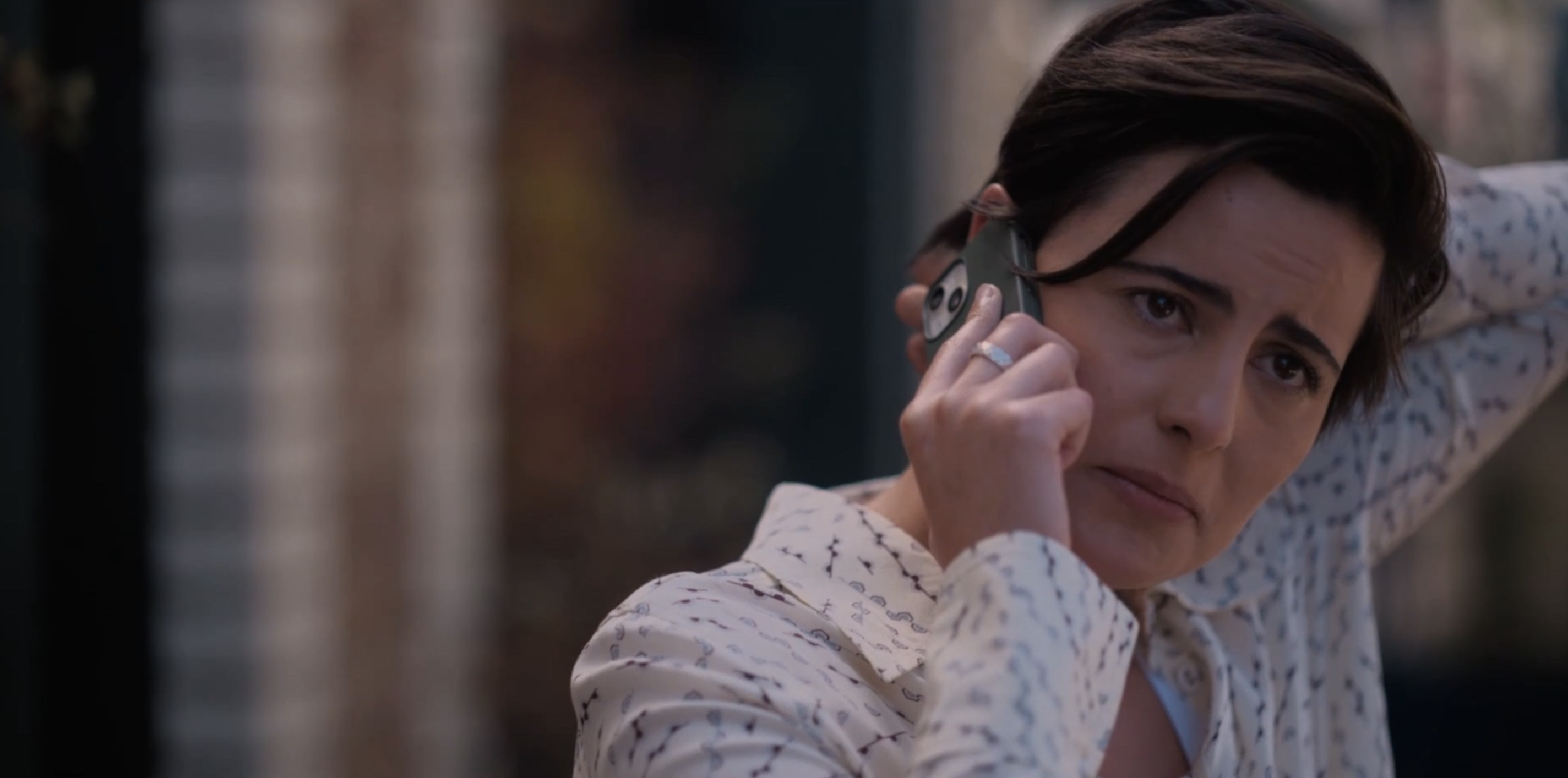 Finley on the phone scratching the back of her neck