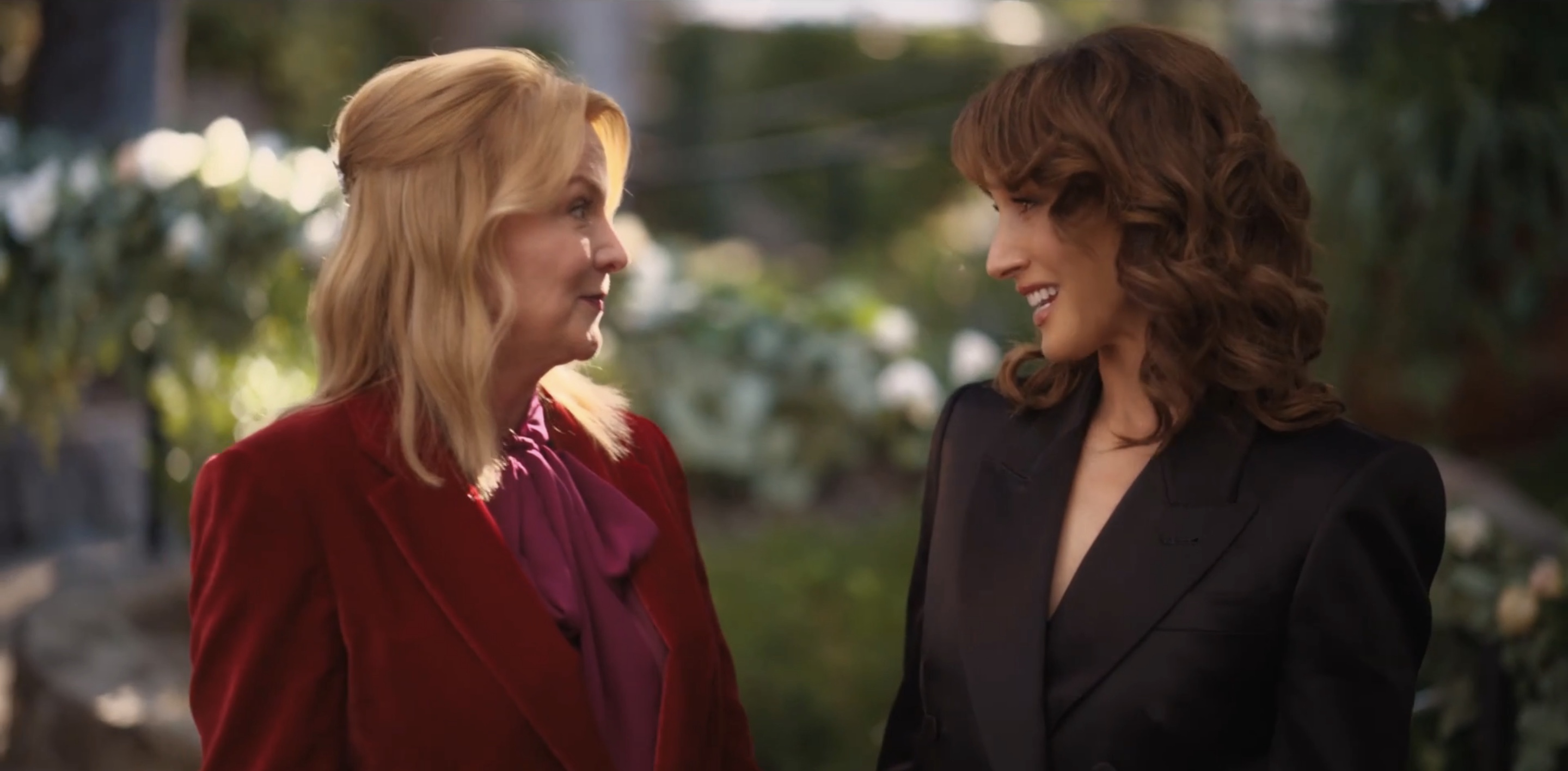Bette and Tina smiling at each other