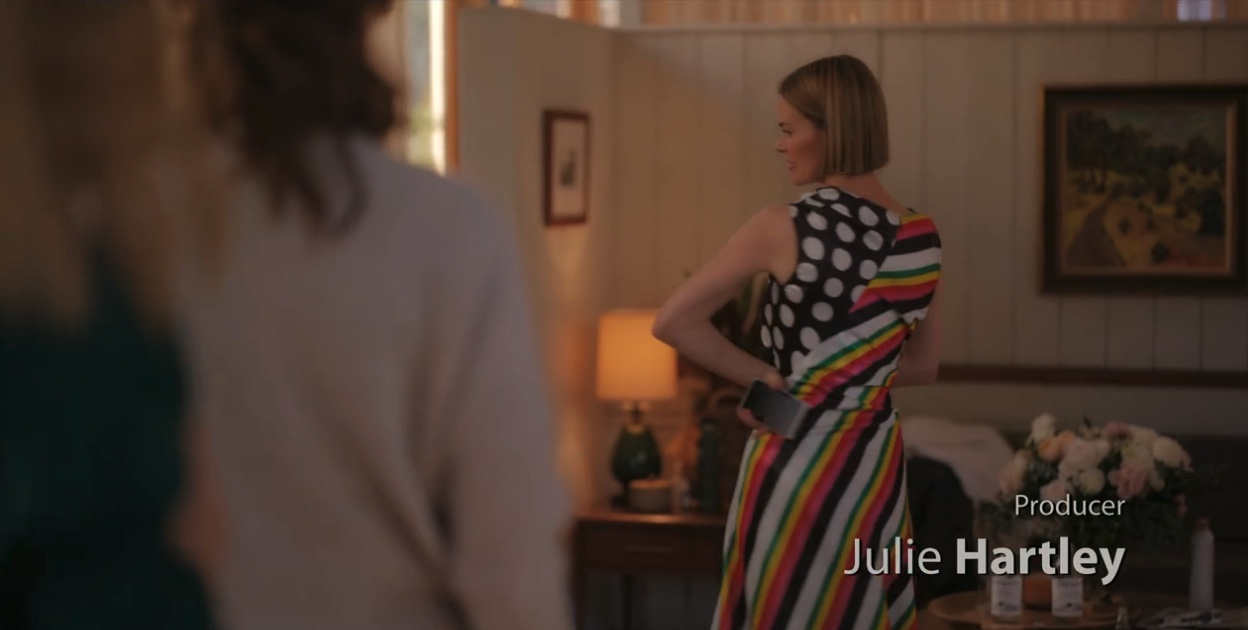 Alice checking out her dress in the mirror