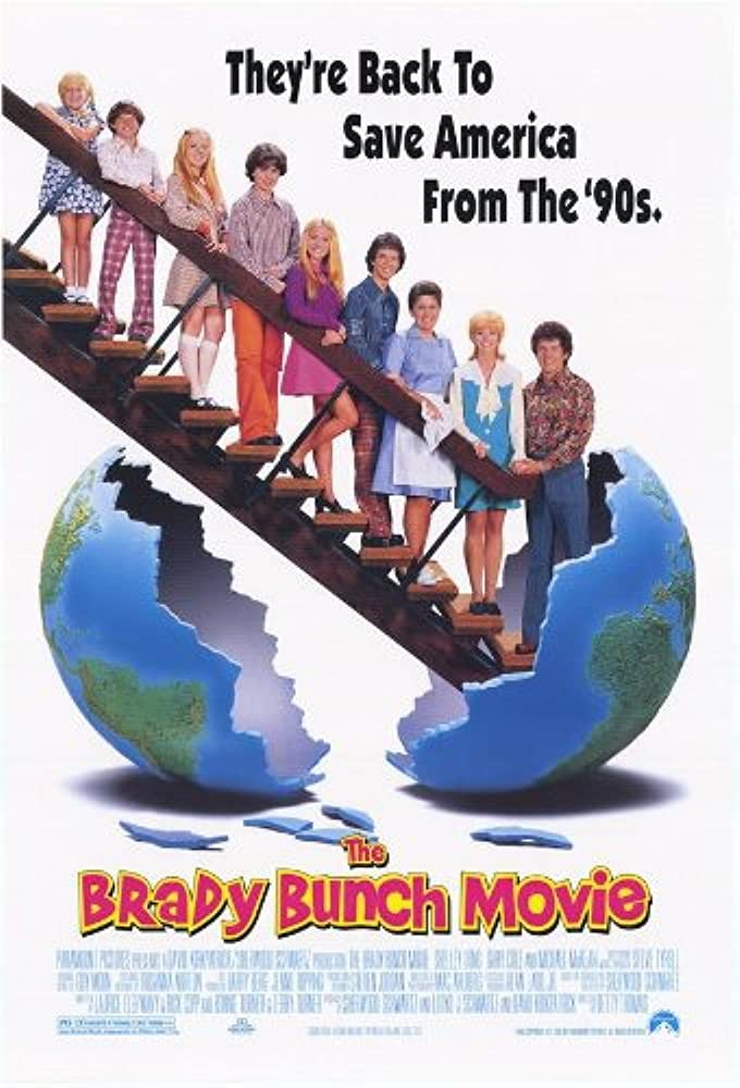 cover of the brady bunch movie featuring that whole family standing in a line on the stairs and a cracked globe at the bottom of the stairs