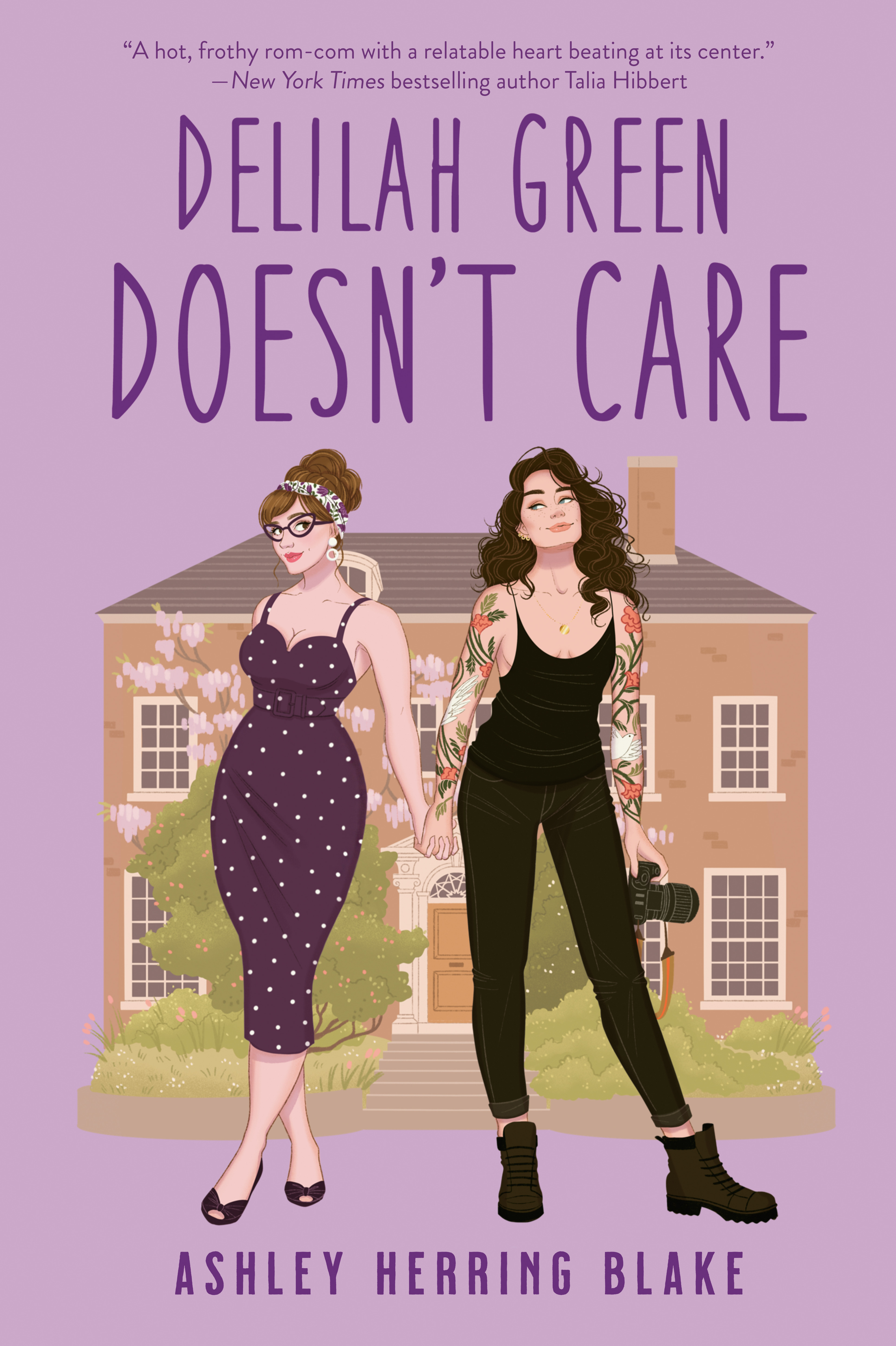 an illustration of two women, one in a dress, one in all black and boots, holding a camera, in front of a house. in purple are the words: delilah green doesn't care
