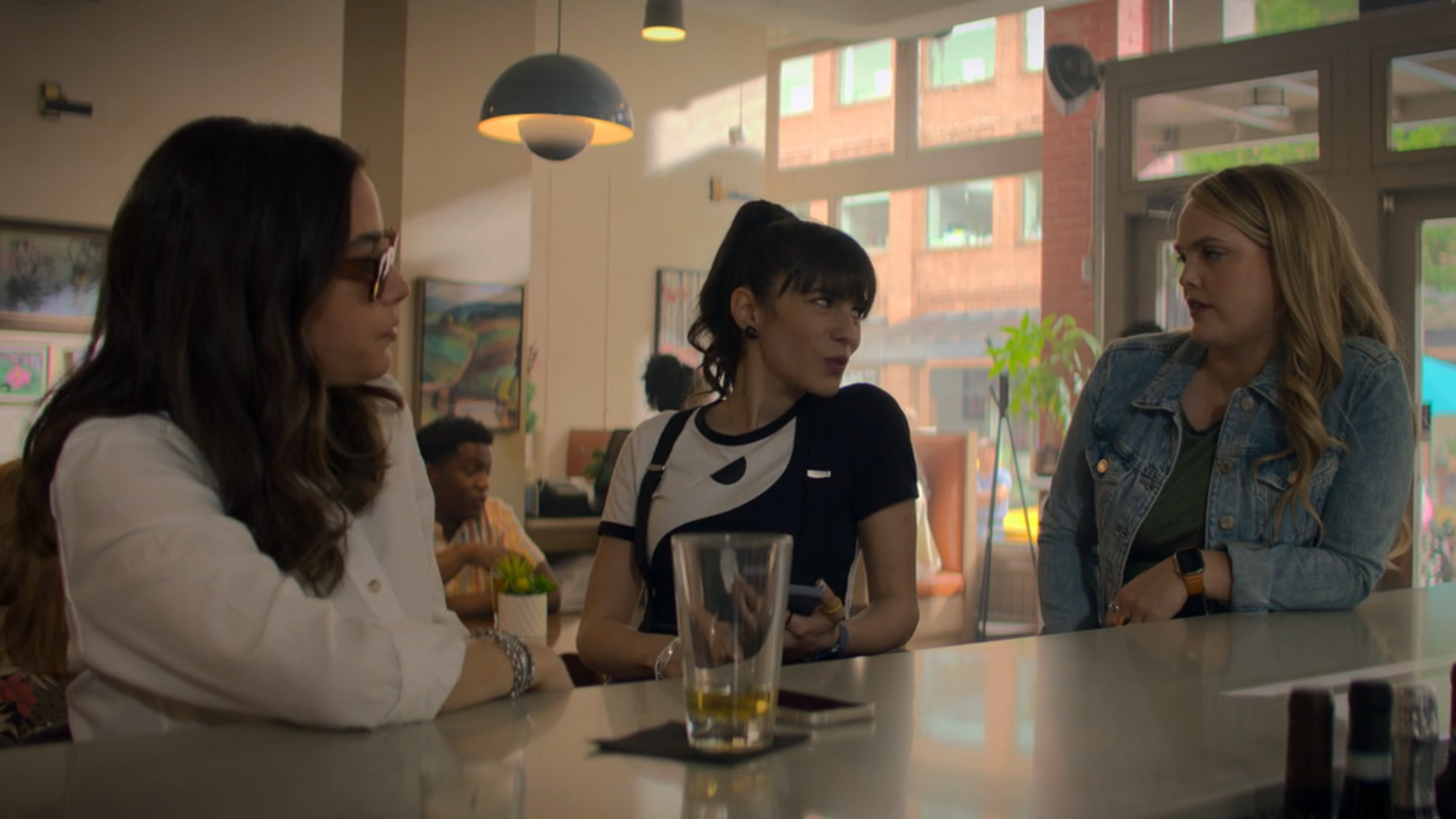 Alex and Kim exchange looks as they sit down at the bar next to Elena.