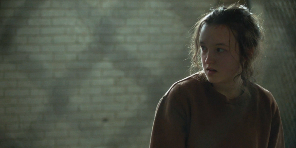 The Last of Us: Ellie stands in a cage, looking disheveled but determined