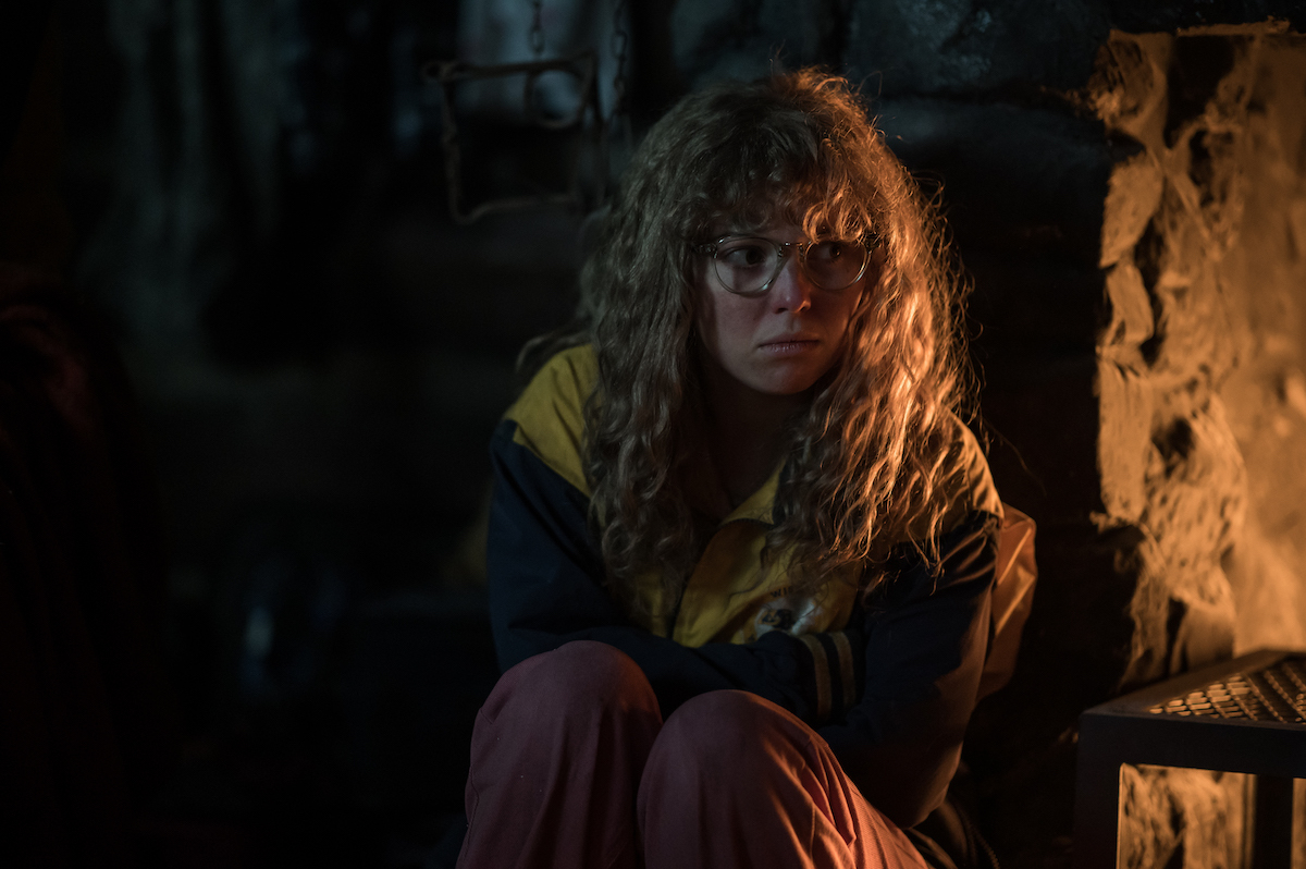 Yellowjackets Samantha Hanratty as Teen Misty in YELLOWJACKETS Season 2 kneels in a dark corner. Photo Credit: Kailey Schwerman/SHOWTIME.