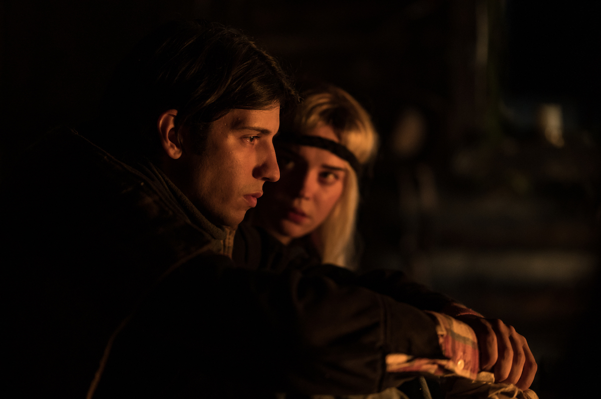 Yellowjackets (L-R): Kevin Alves as Teen Travis and Sophie Thatcher as Teen Natalie in YELLOWJACKETS Season 2 talking in the cabin. Photo Credit: Kailey Schwerman/SHOWTIME.