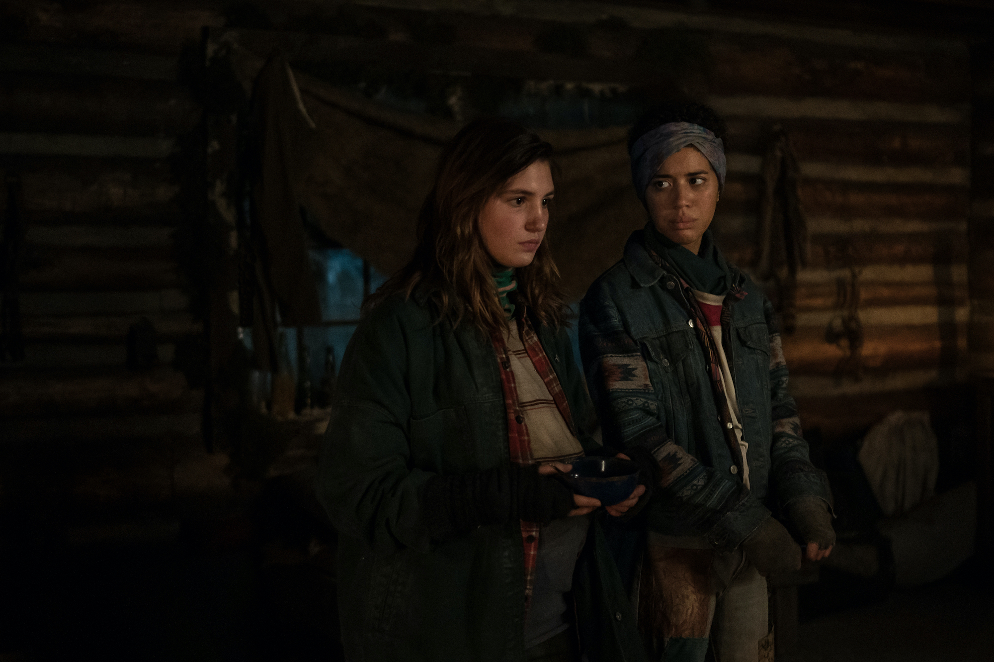 Yellowjackets (L-R): Sophie Nélisse as Teen Shauna and Jasmin Savoy Brown as Teen Taissa in YELLOWJACKETS Season 2 are in the cabin. Photo Credit: Kailey Schwerman/SHOWTIME.