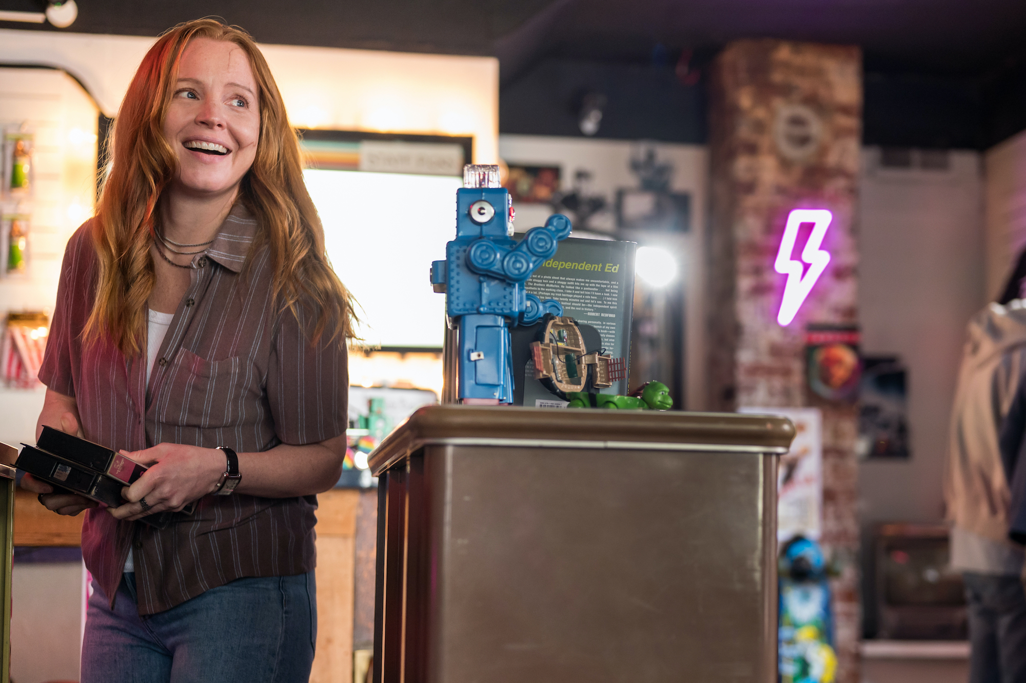 Yellowjackets - Season 2 Lauren Ambrose as Van in YELLOWJACKETS Season 2 smiles near a podium. Photo Credit: Kailey Schwerman/SHOWTIME.
