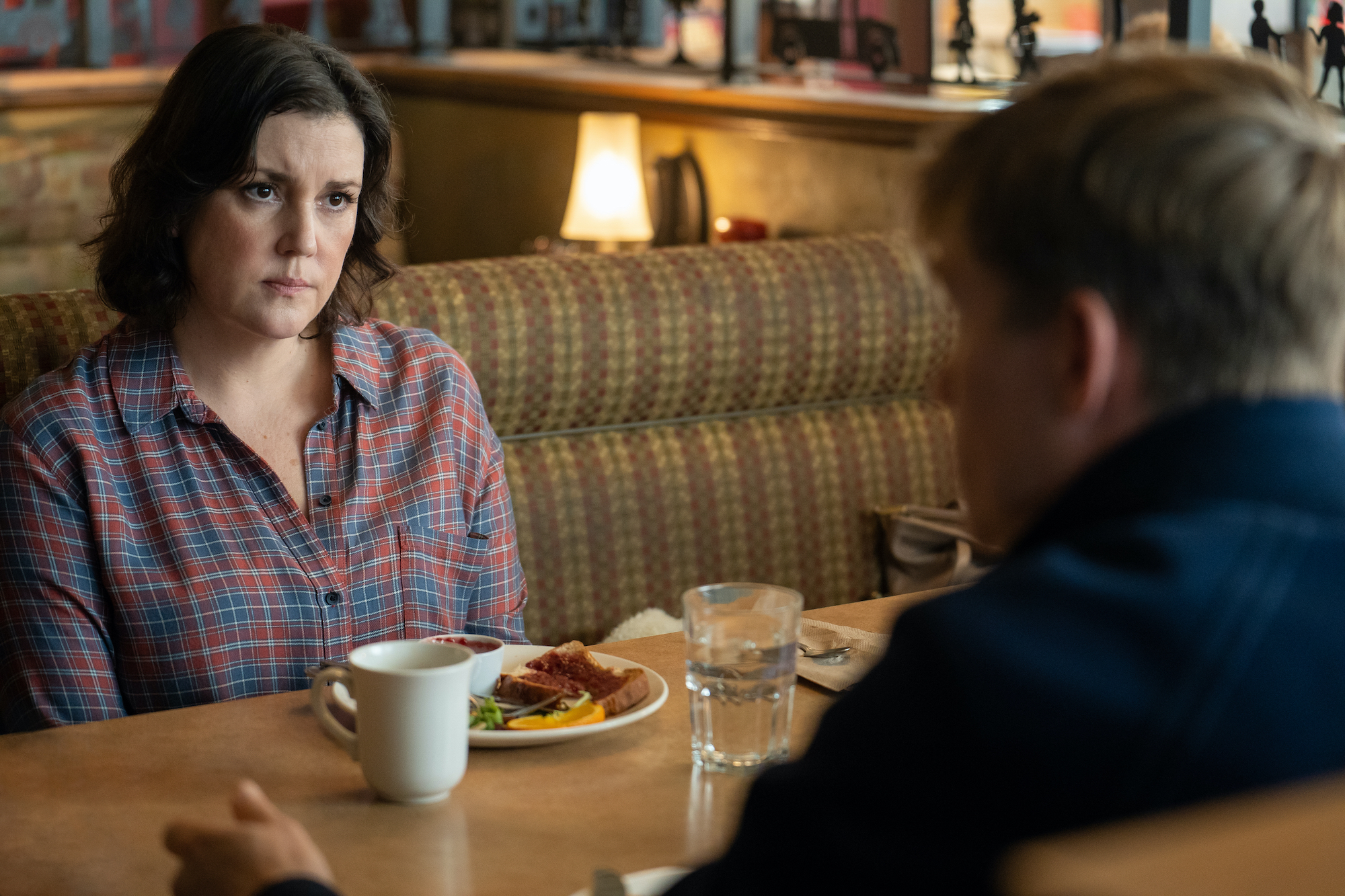 Yellowjackets - Season 2 Melanie Lynskey as Shauna in YELLOWJACKETS Season 2 is in a diner booth across from Jeff. Photo Credit: Colin Bentley/SHOWTIME.