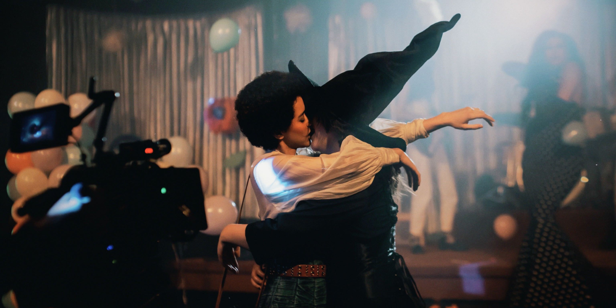 Jasmin Savoy Brown kisses Lucy Dacus who is wearing a witch costume in the 