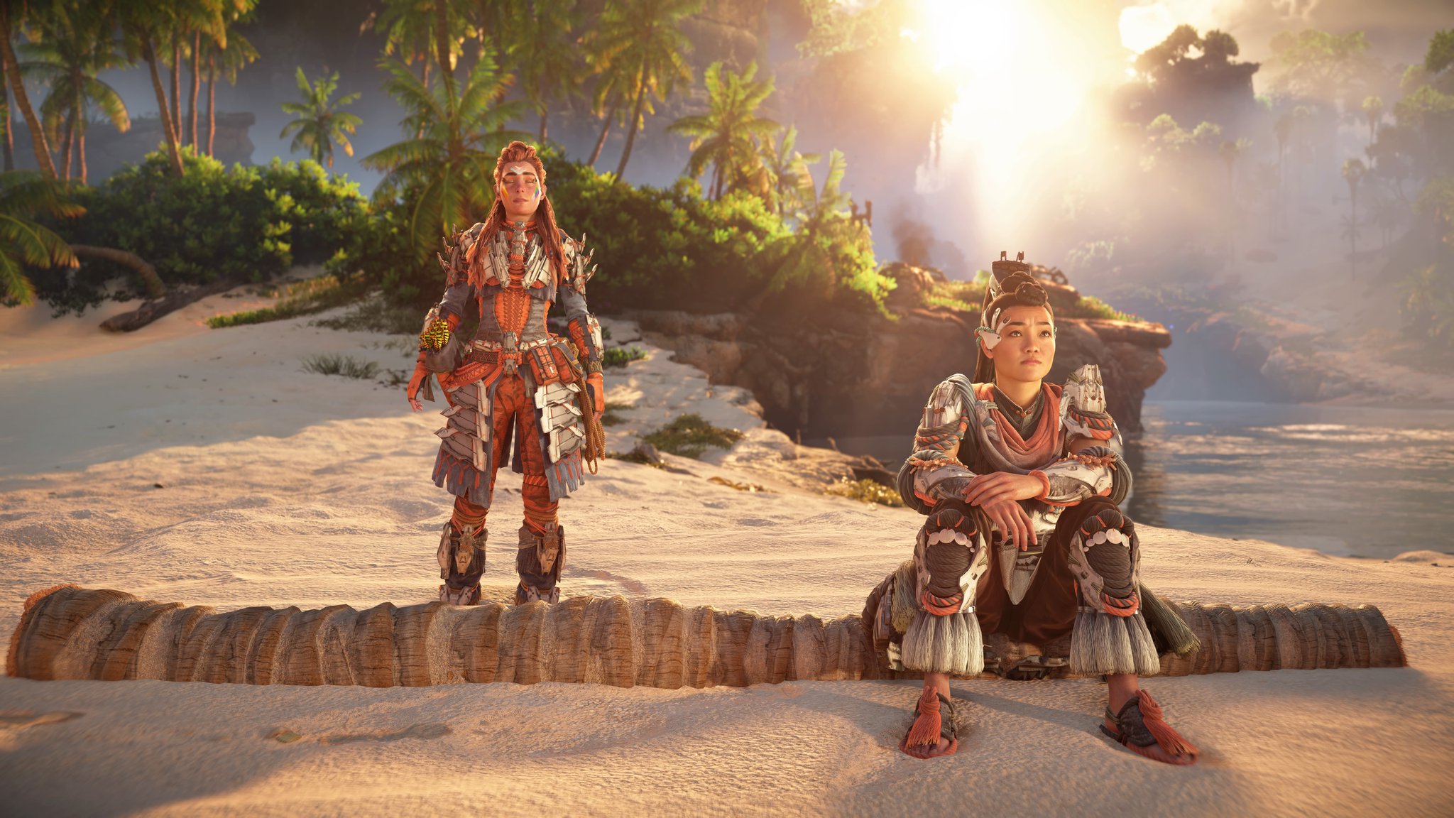 Seyka sits on a log on the beach. Aloy stands behind her.