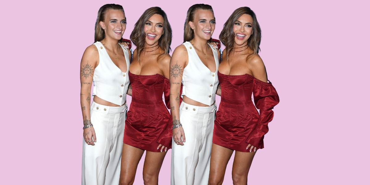 G Flip and Chrishell Stause on a red carpet together. G Flip is in a white vest and white pants, and Chrishell is in an off the shoulder red long sleeved mini dress