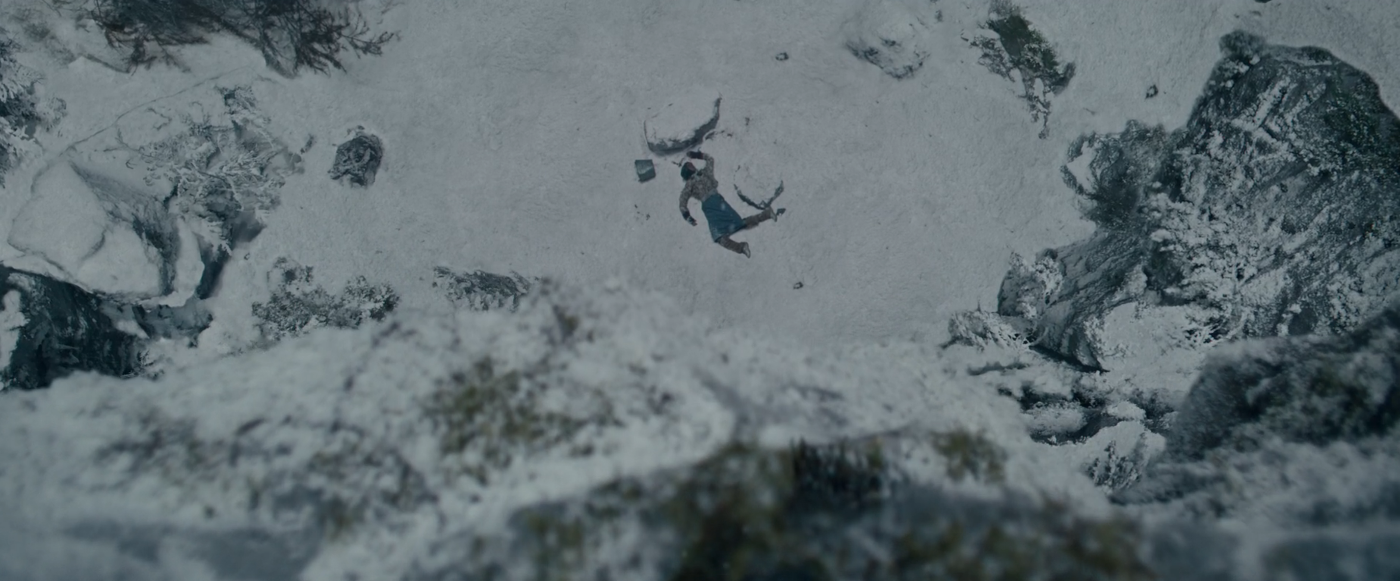 a body sprawled in the snow from above