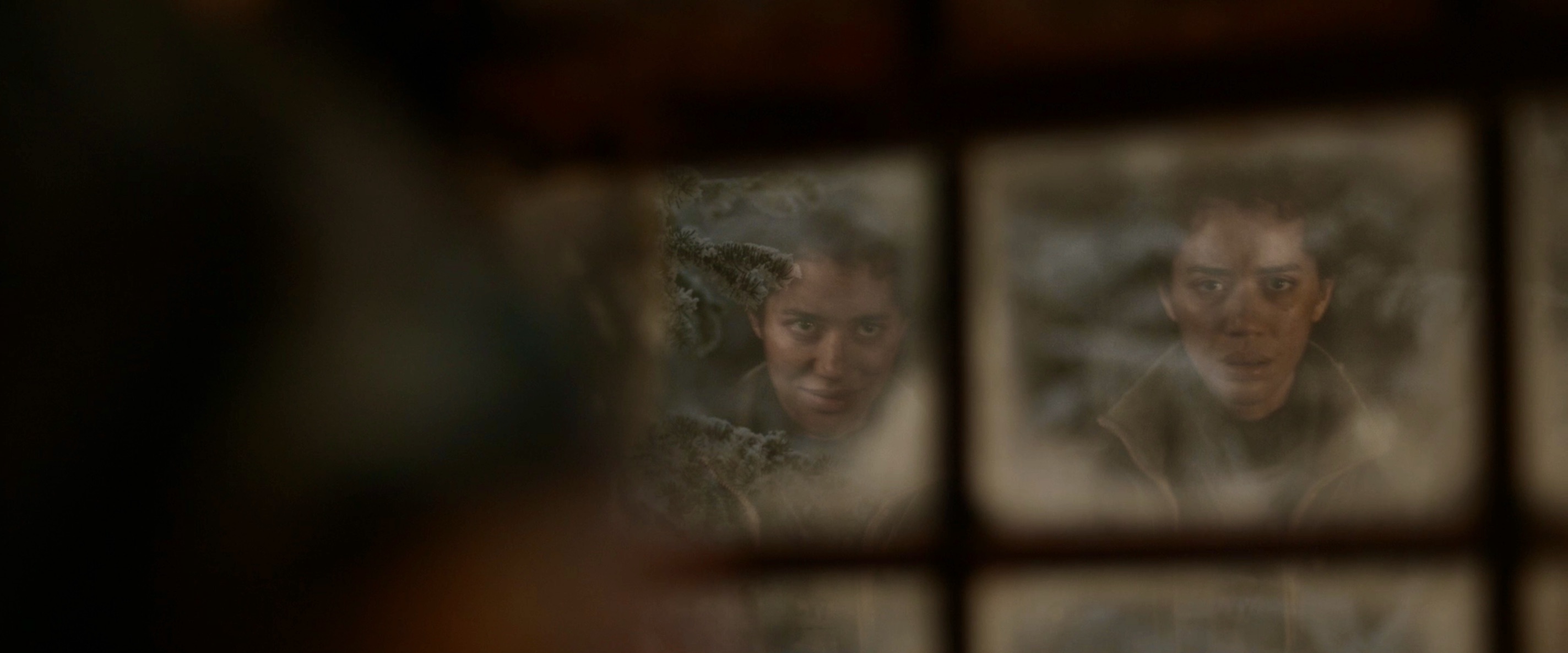 Other Tai smiles at Tai in a snowy windowpane in Yellowjackets 208