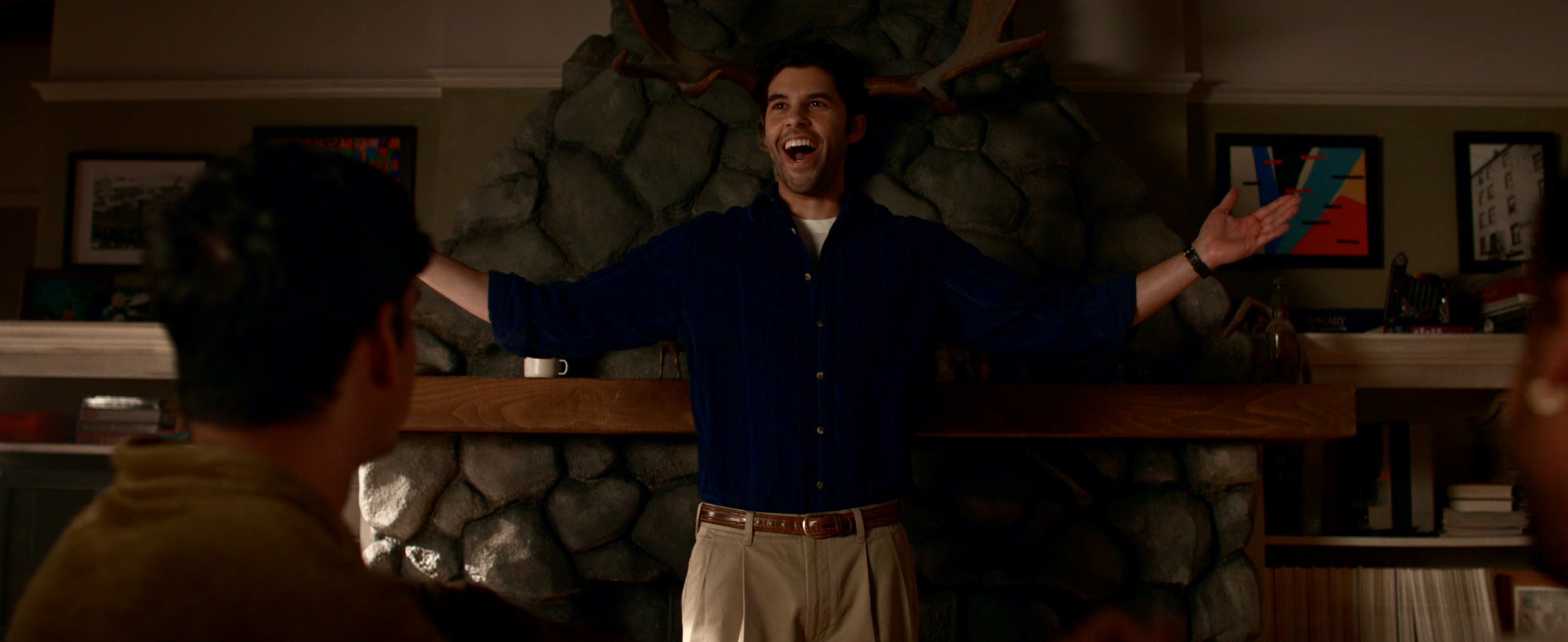 Ben with moose antlers behind him, holding his arms out