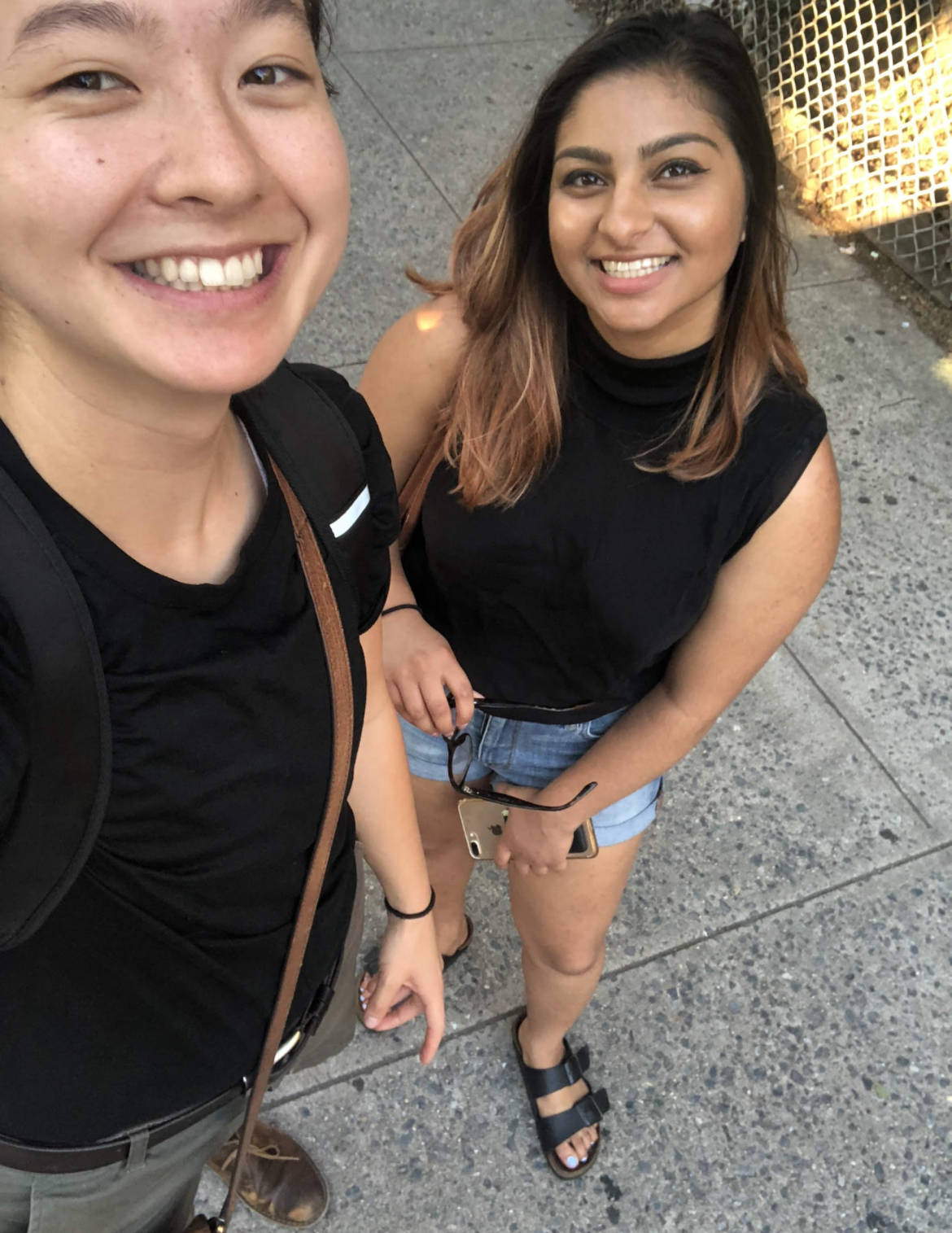 MR (left) and Ashni (right) are looking up at the camera. Both are wearing black tops.