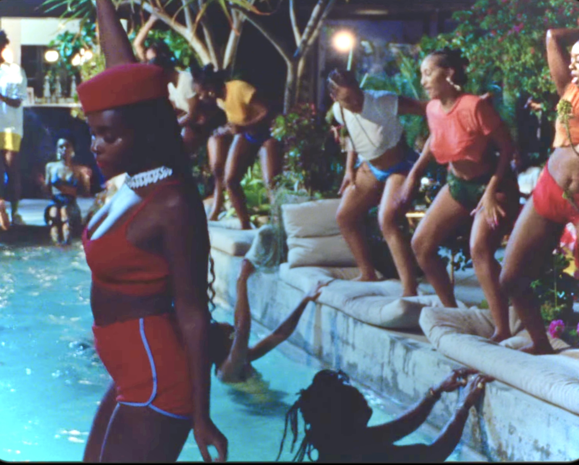 Janelle Monáe at a pool party in their music video.