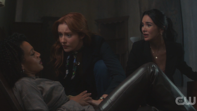 Bess and Nancy lean over the injured Laci