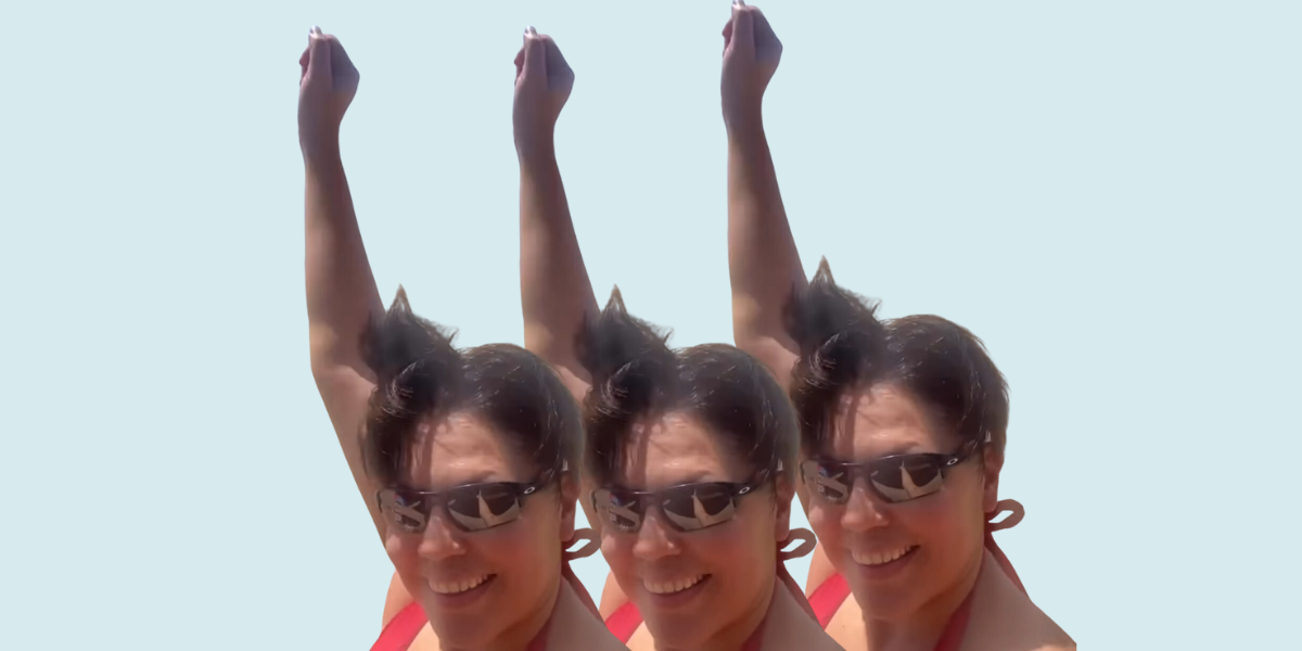 Sara Ramirez in a red bathing suit dancing on the beach