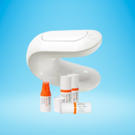 The PULSE automatic lube warmer and dispenser is against a light blue background. It's made of white plastic and it's shaped like a C. Three small orange and white bottles of lube standing in front of the device. One is open. A fourth is on its side.