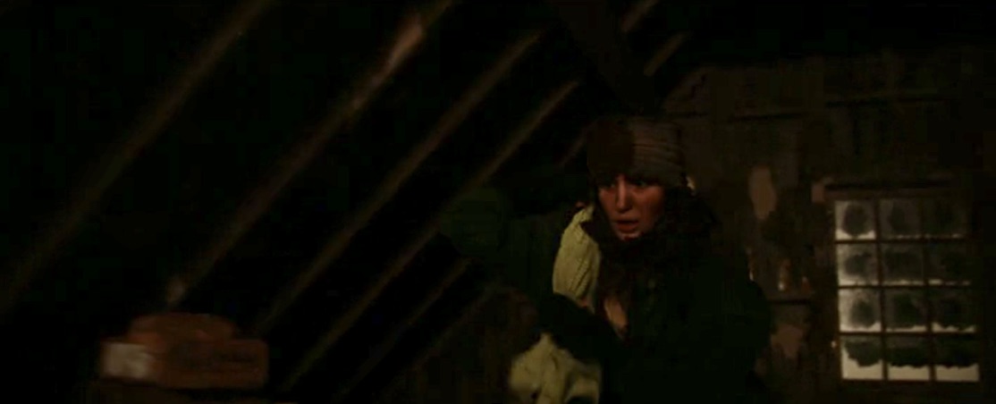 Teen Shauna carries a dress out of the attic in the season two finale of Yellowjackets