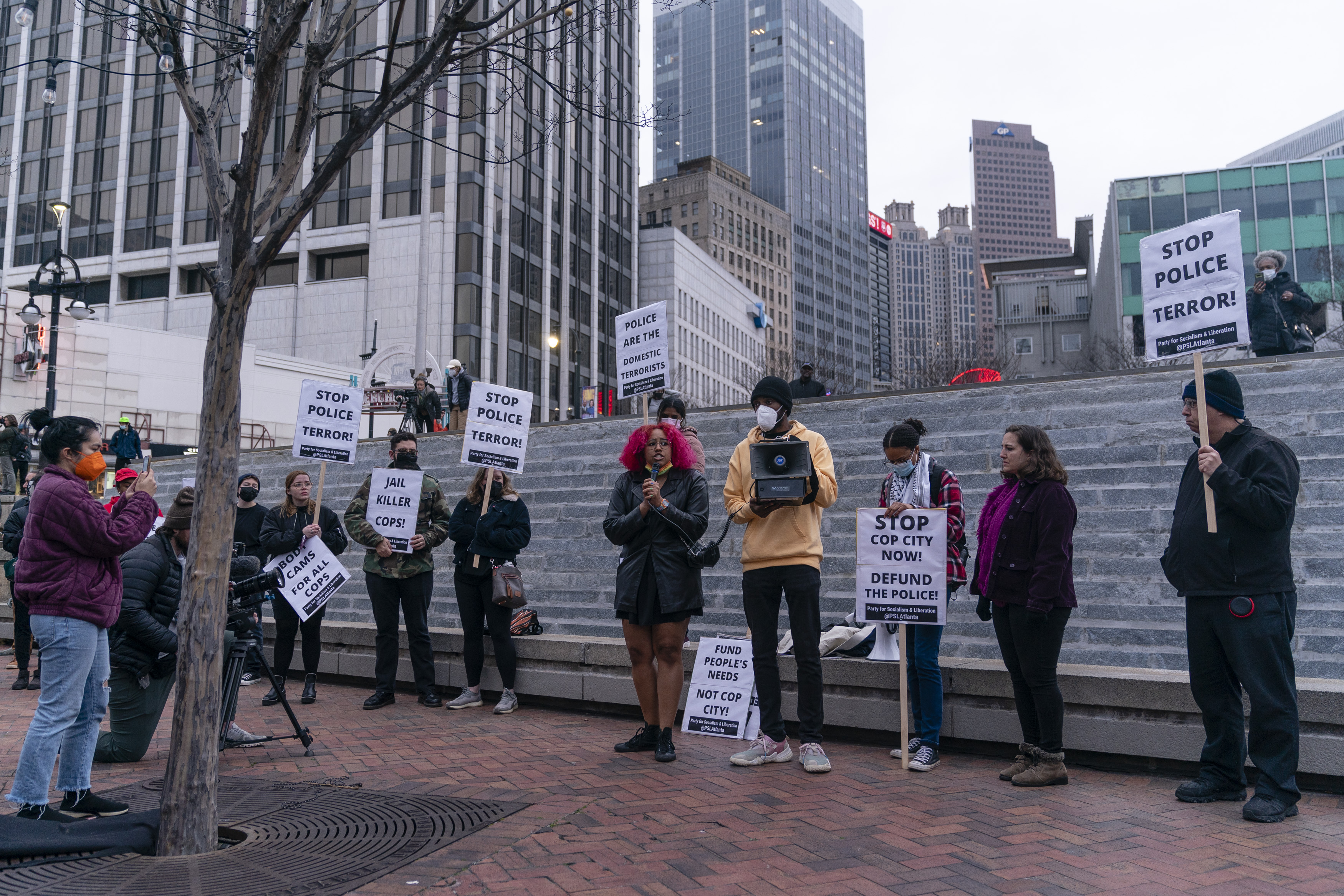 ATLANTA, GA - JANUARY 21- A woman speaks during a protest following the shooting death of Manuel Teran during a police raid on their encampment inside Weelaunee People's Park, the site of the proposed 'Cop City' training facility, earlier in the week, on Saturday, January 21, 2022 in Atlanta, GA.