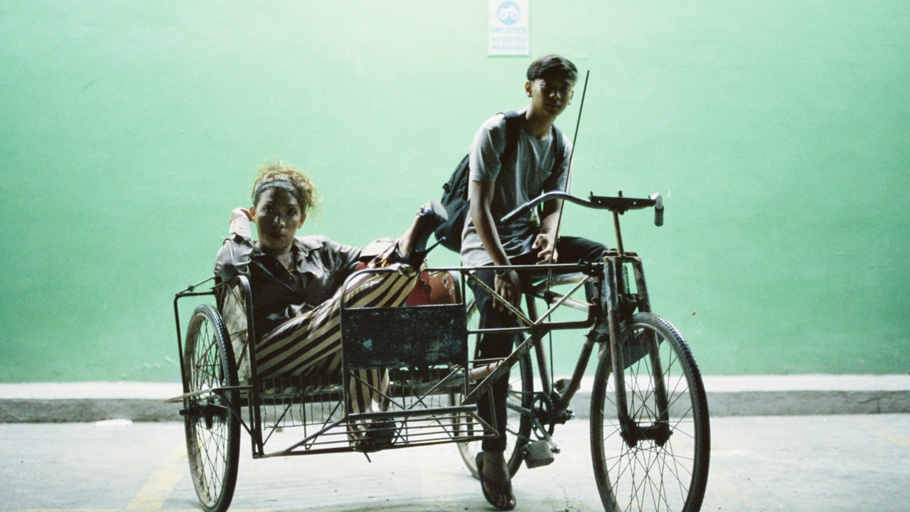 A Filipino taxi bike with a trans woman in back