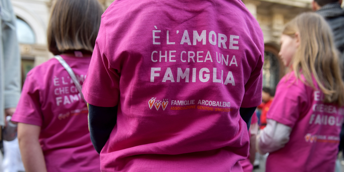 children at a protest in Italy in support of queer parental rights, wearing shirts that say 