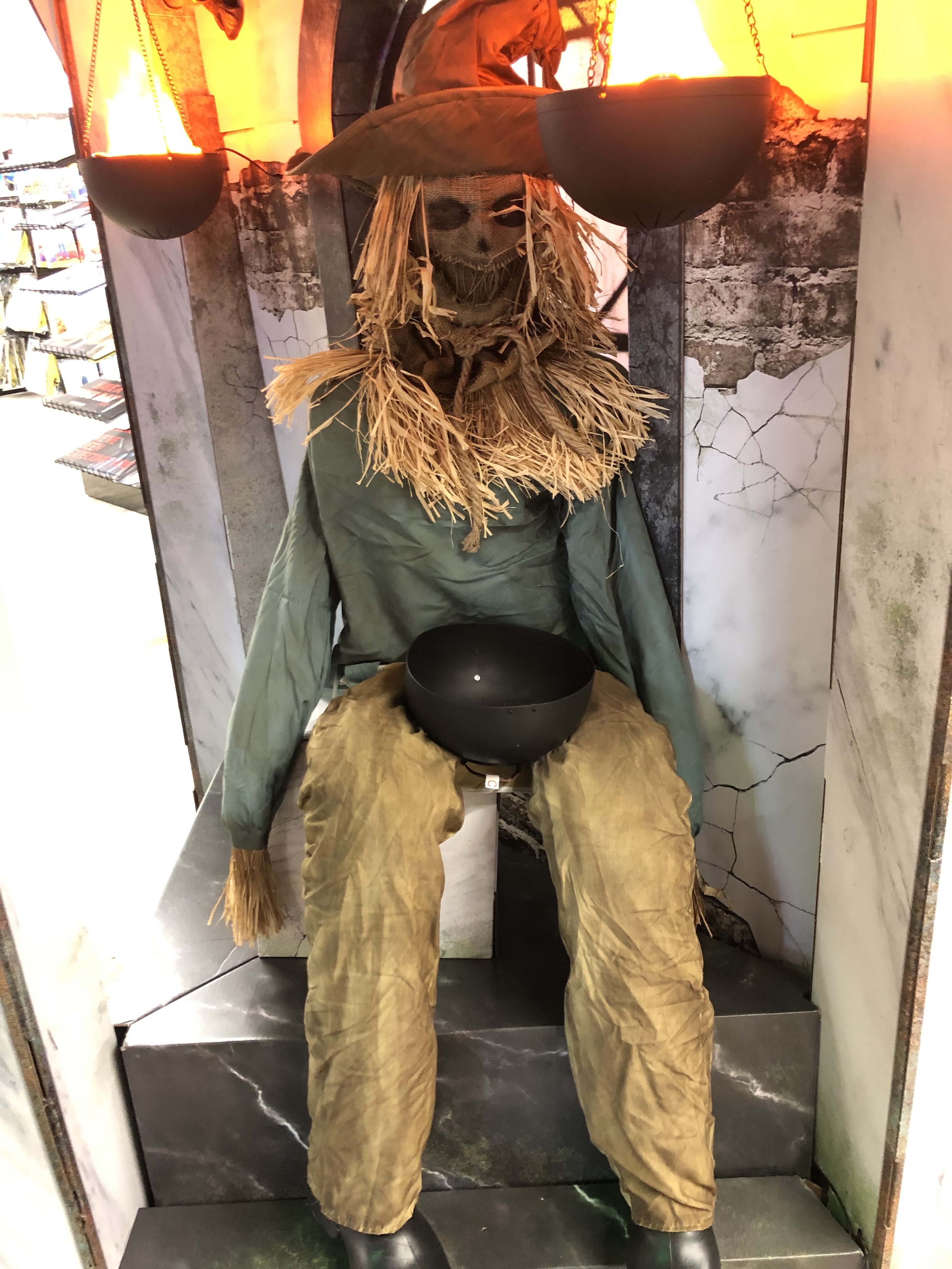 a haunted looking scarecrow in a sitting position