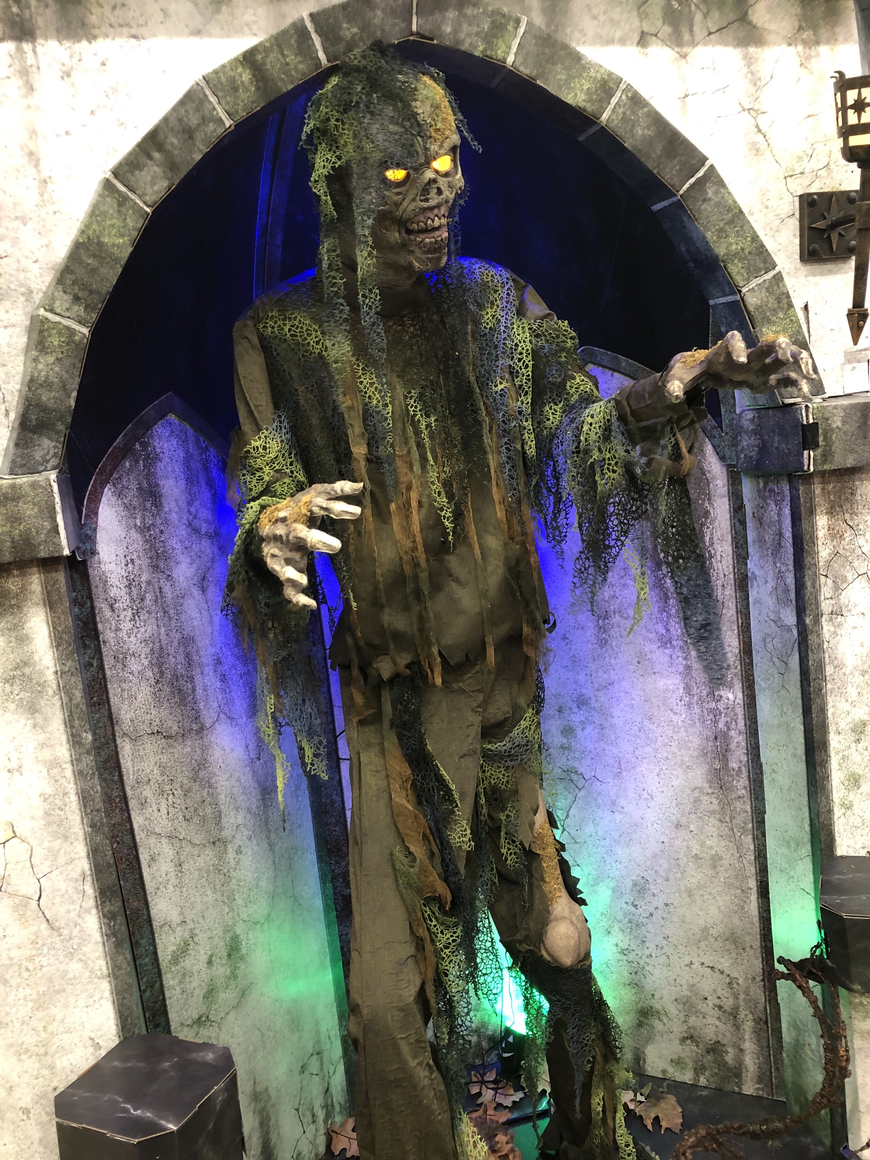 a zombie animatronic covered in seaweed/swampy stuff