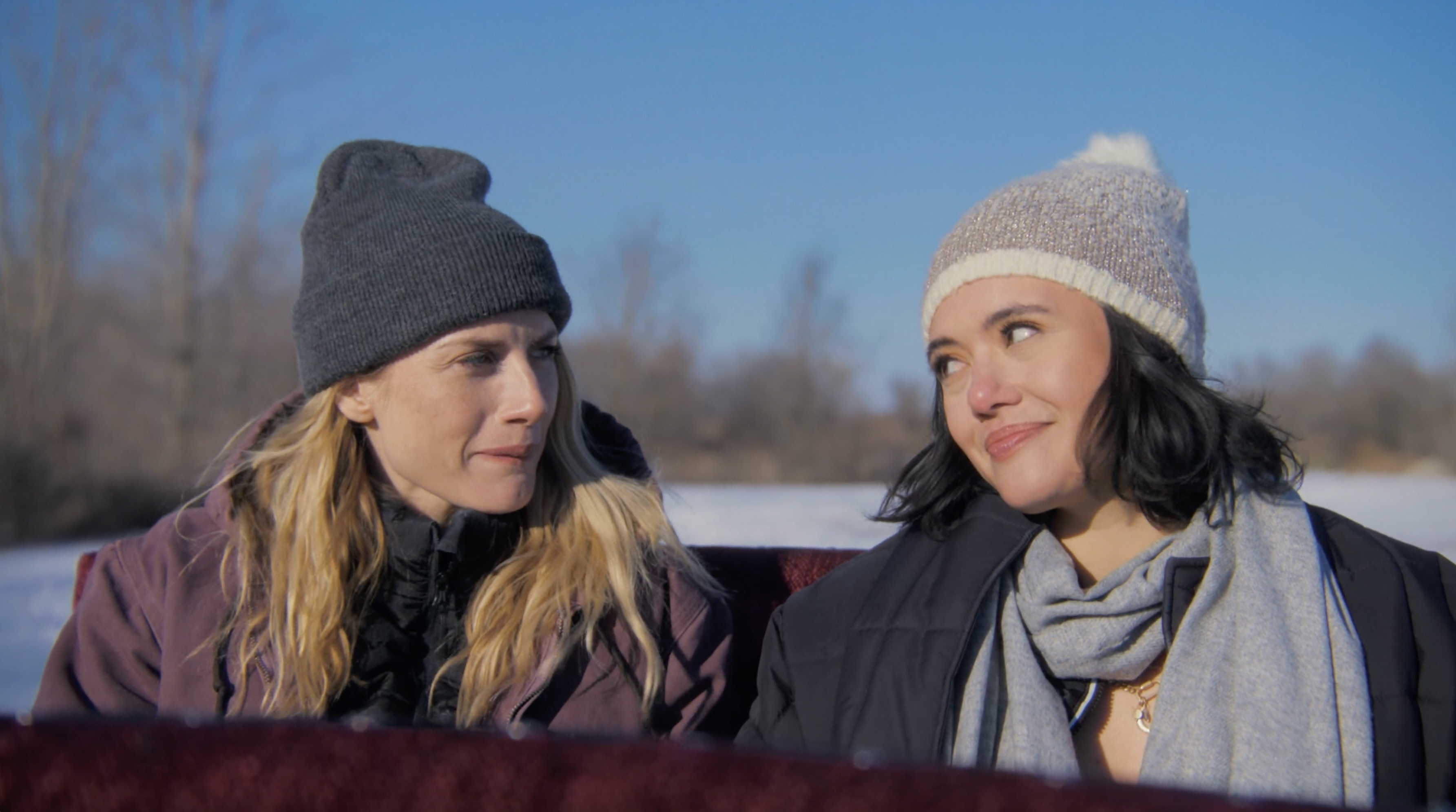 Lindsay Hicks and Rivkah Reyes make eyes at each other in a horse drawn carriage.